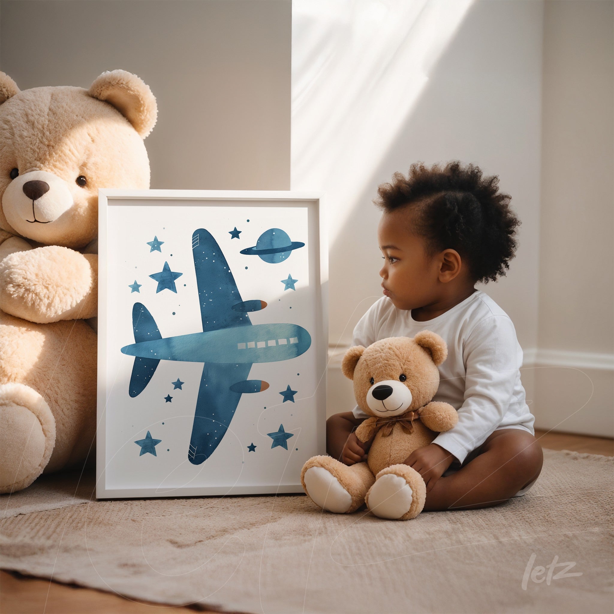 decorative artwork featuring a blue airplane and planets in a white frame, displayed next to a child and teddy bears