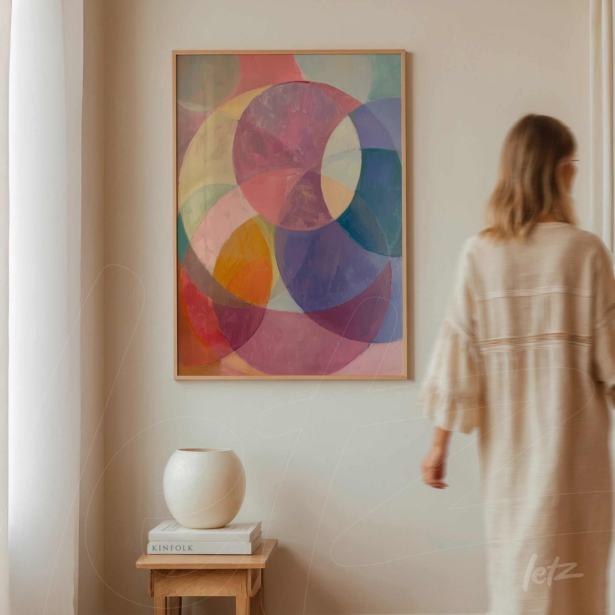 abstract art piece with pink, blue, and purple circles in a light wood frame
