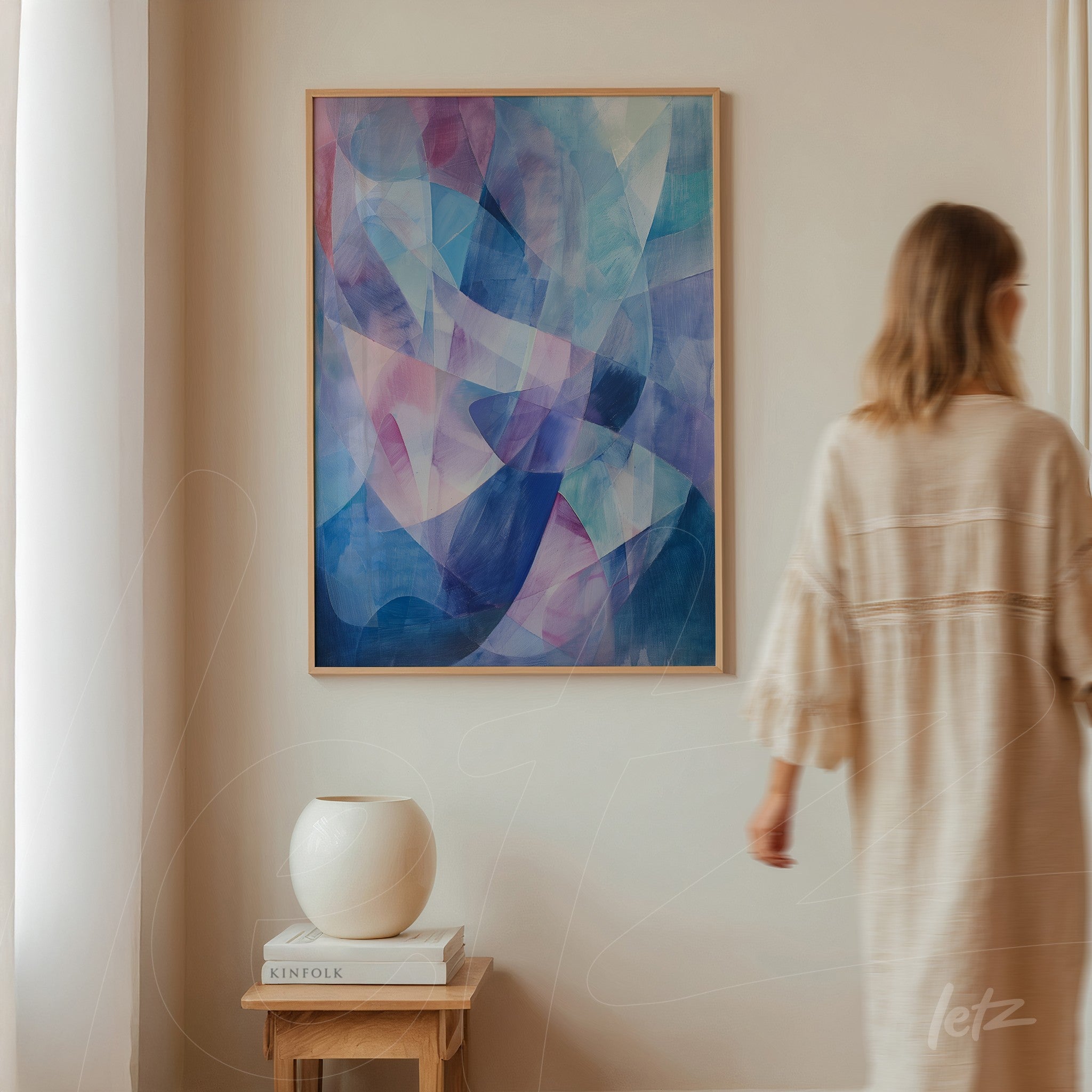 abstract artwork in shades of blue and purple in light frame displayed on beige wall