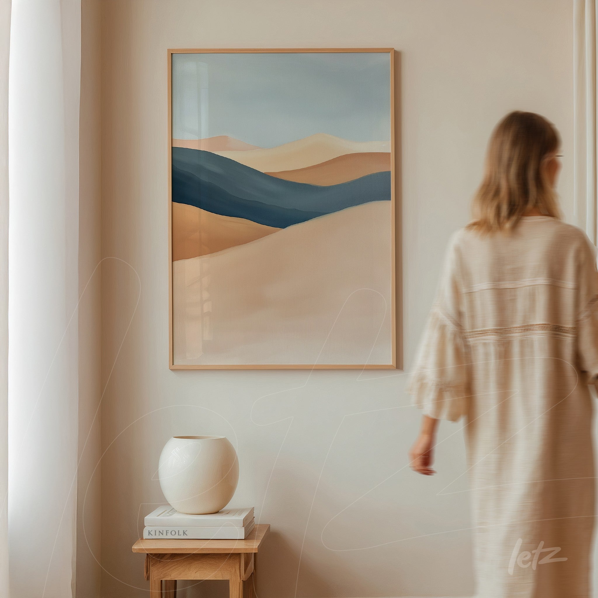 abstract wall art in earthy and blue tones, light wood frame, displayed on neutral wall next to a white vase