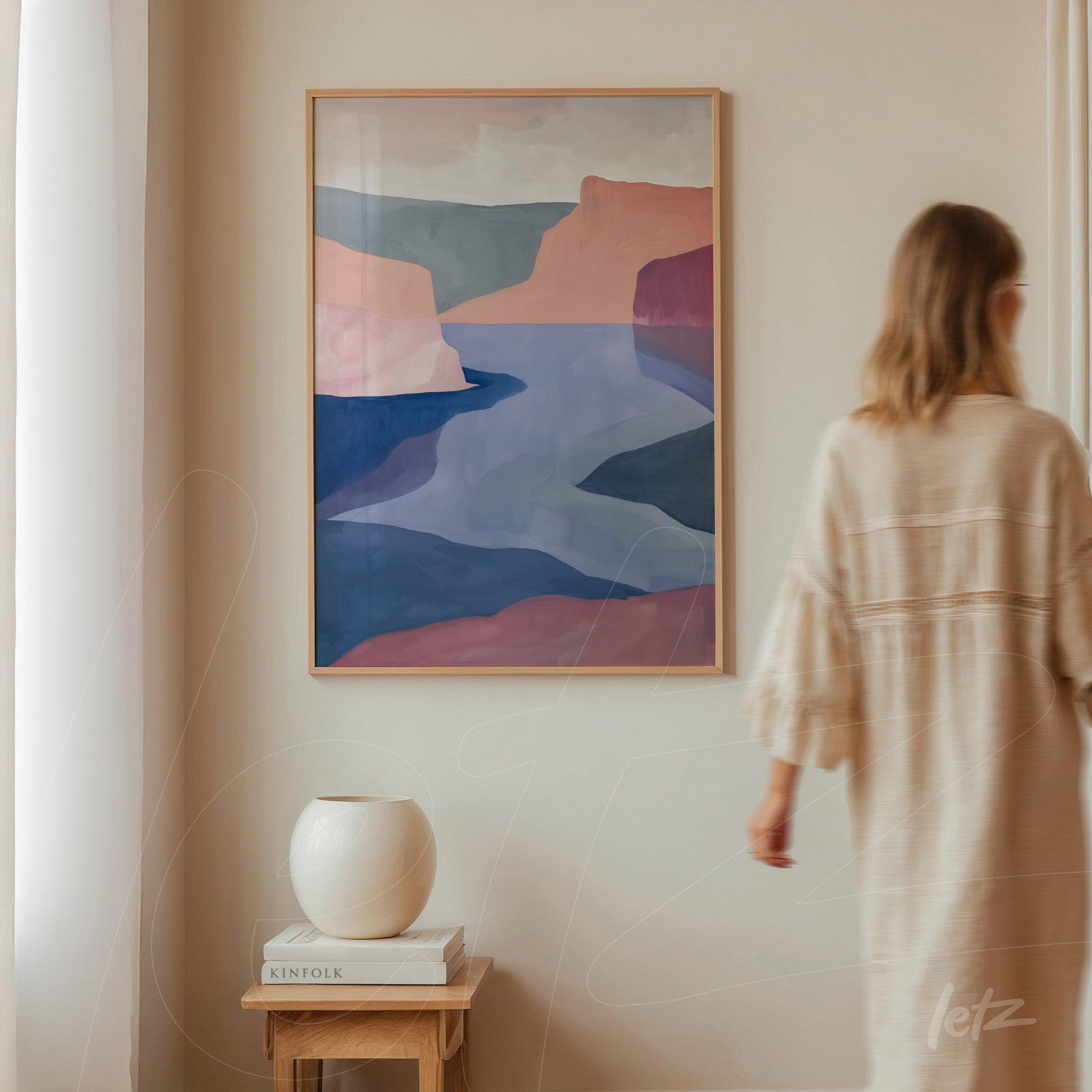 abstract landscape art with fluid shapes in light wood frame displayed on a neutral wall