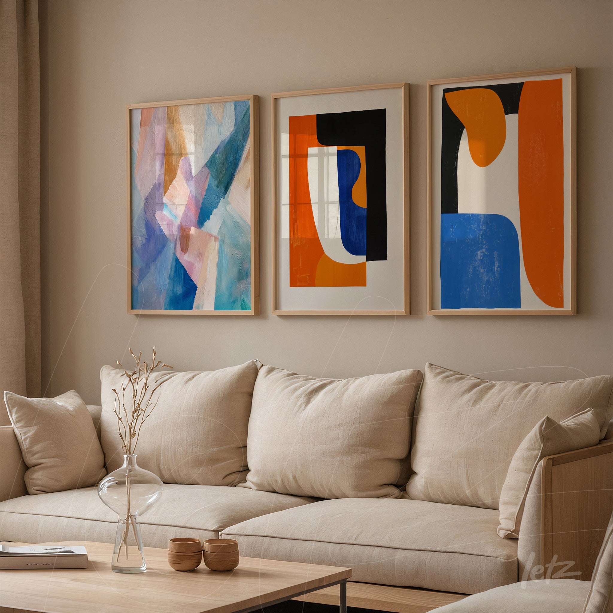 set of modern wall art featuring abstract shapes in light wooden frames against a neutral wall