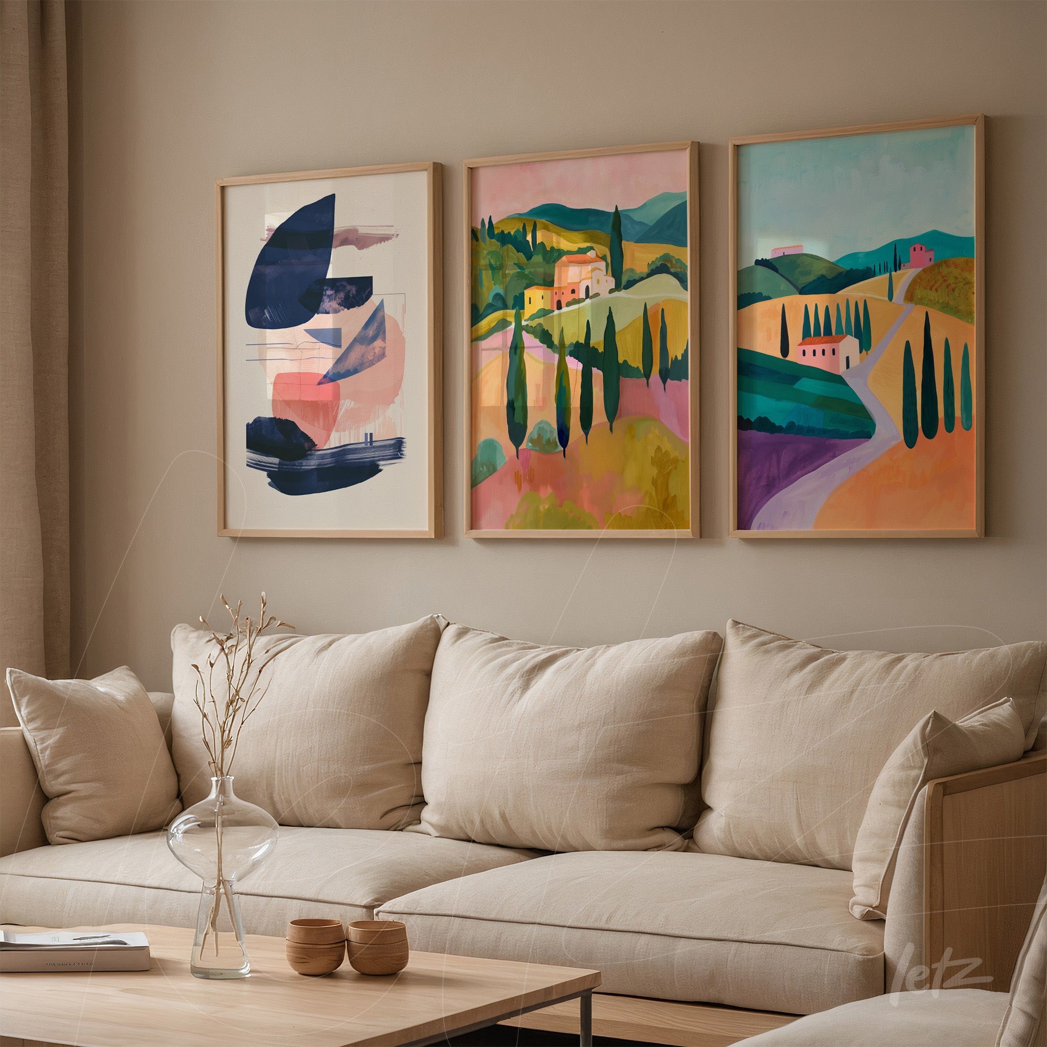 set of decorative framed artworks featuring colorful landscapes displayed on a neutral wall above a light-colored sofa with soft cushions