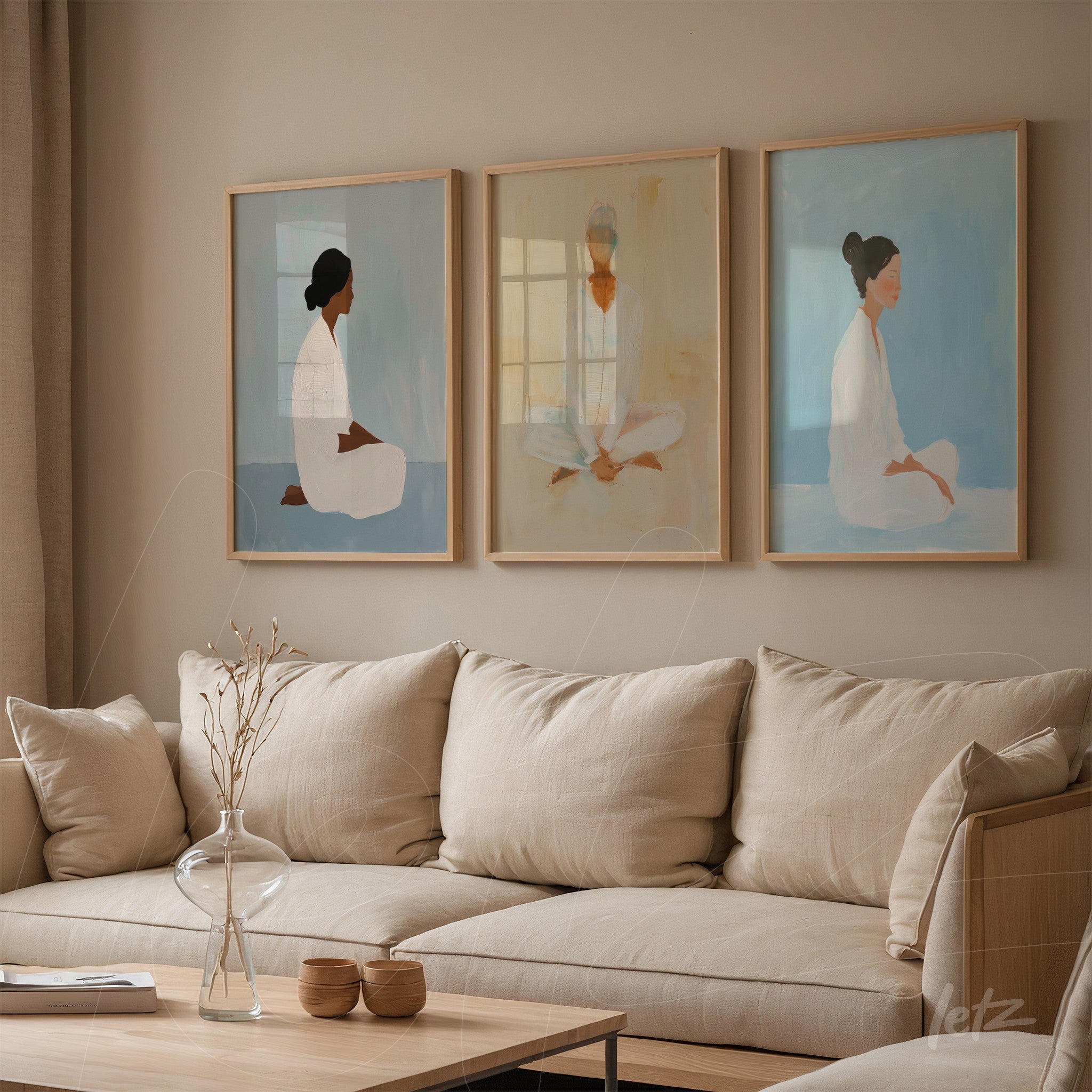 three framed illustrations of serene female figures in light wood frames on a beige wall
