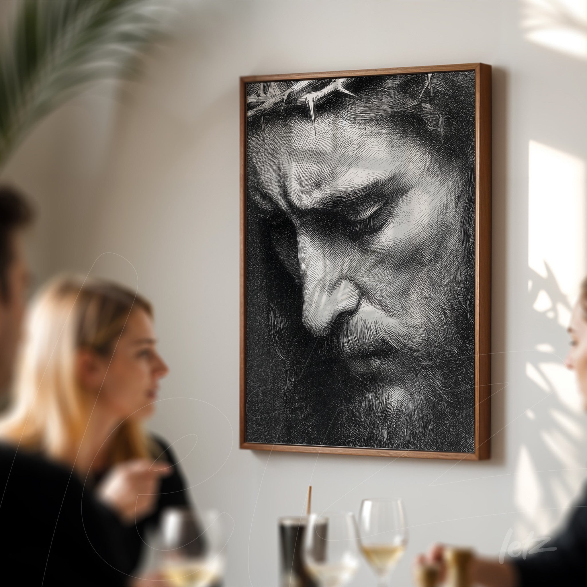 framed black and white portrait of a man with thorn crown displayed on wall