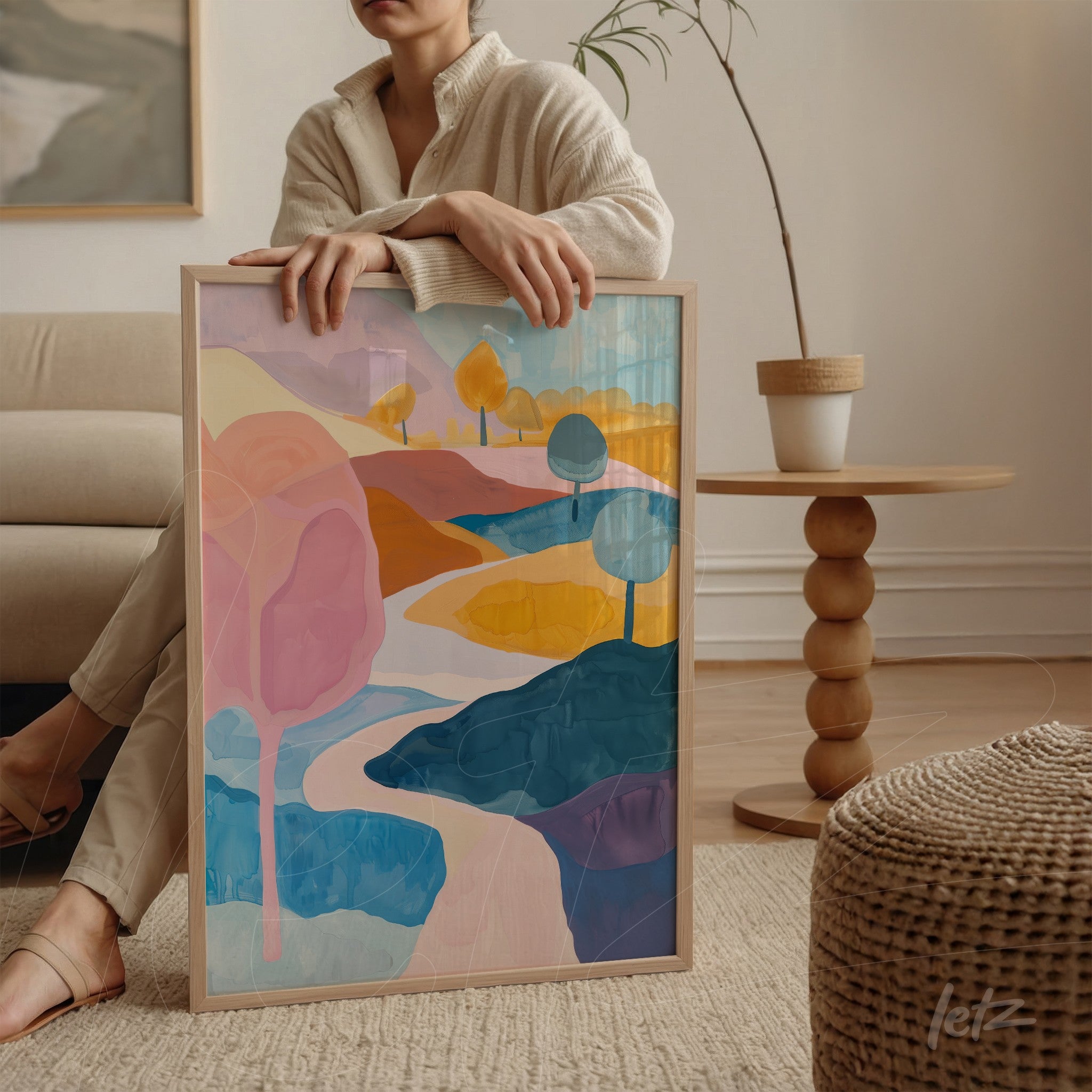 framed art piece featuring an abstract landscape with soft colors like pink, blue, and yellow, showcasing stylized trees