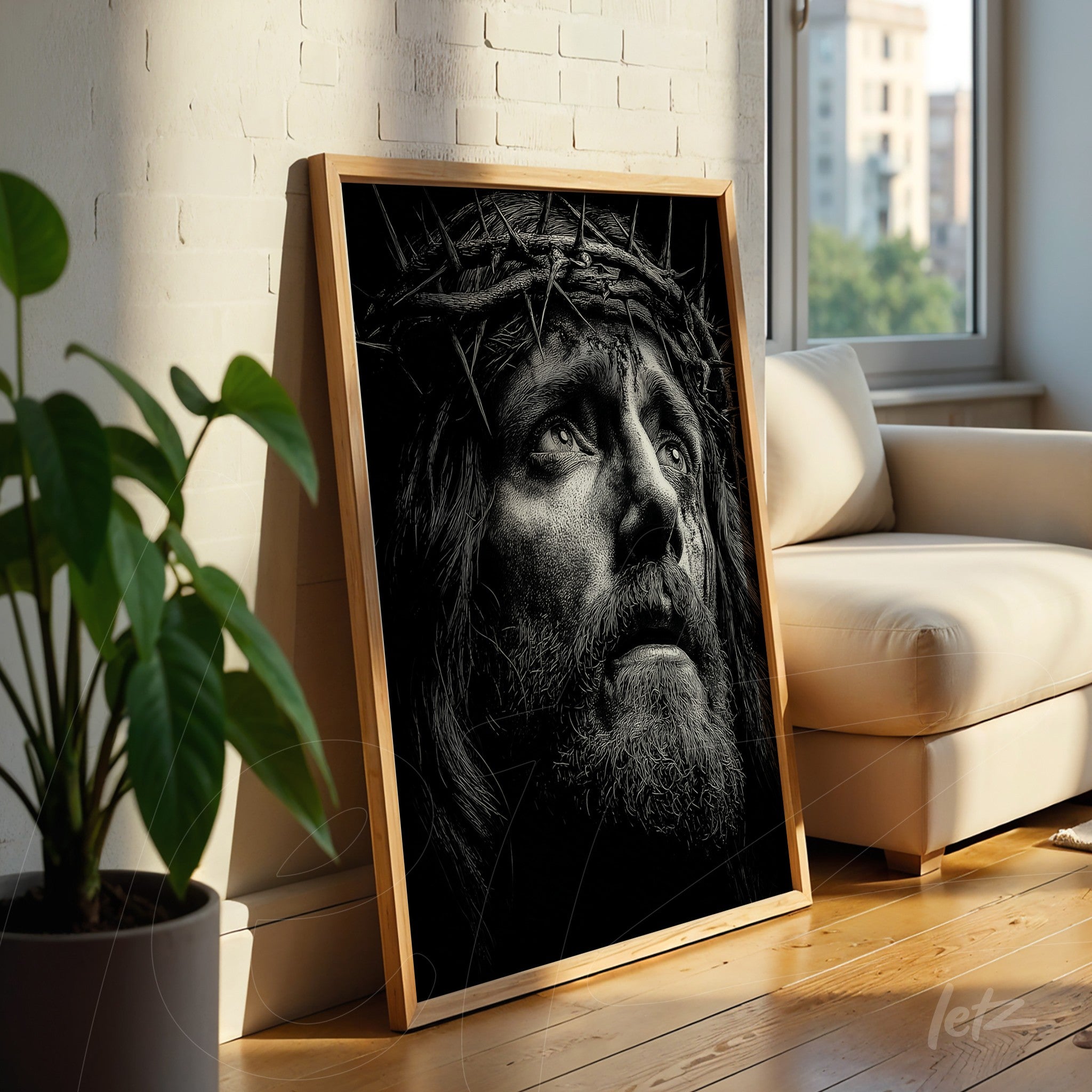 black and white framed art of Christ with a crown of thorns in light wood frame