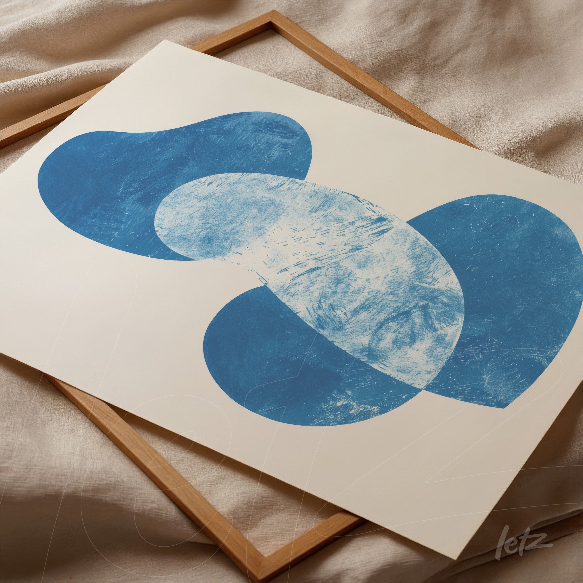 modern wall art featuring organic blue shapes on a neutral background in a light wood frame