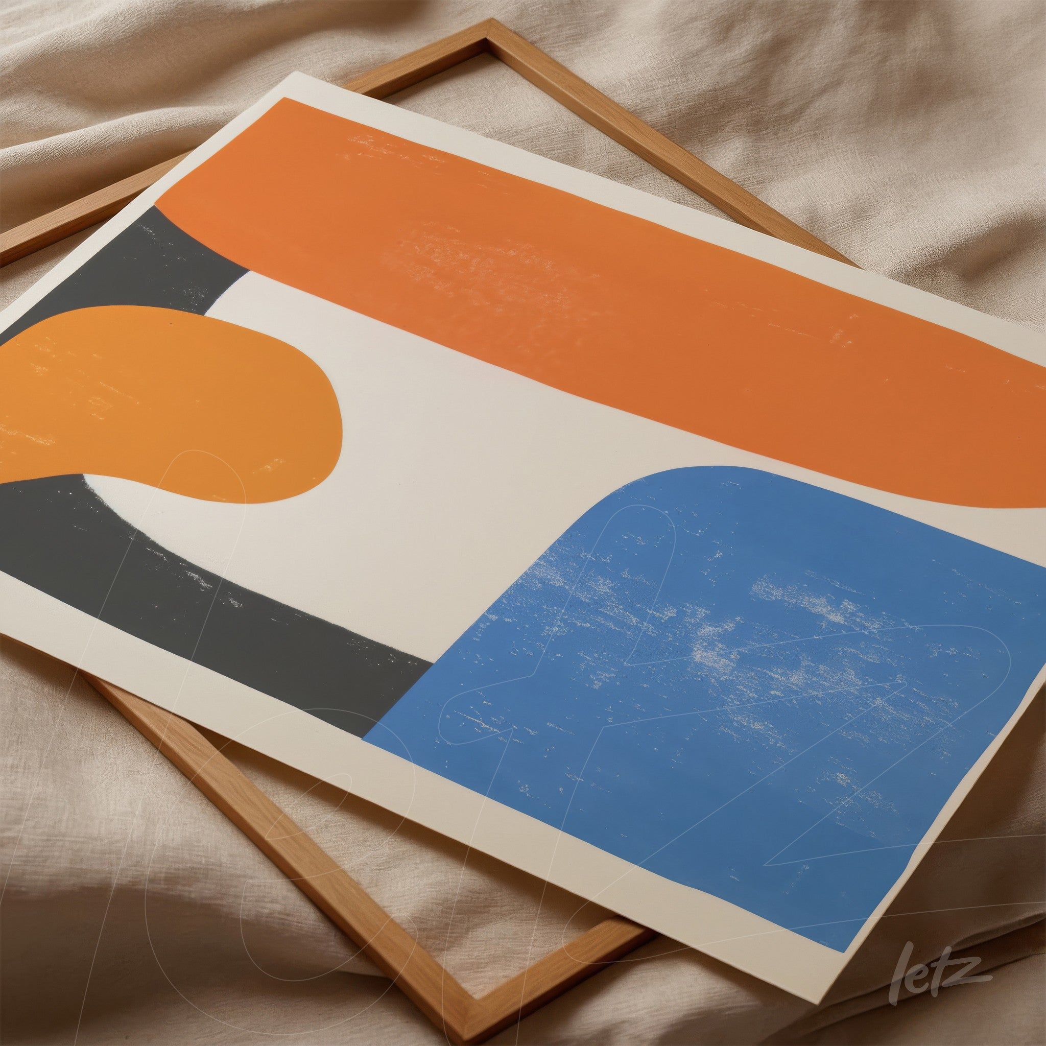 framed abstract artwork featuring vibrant colors and geometric shapes in orange, blue, and gray resting on a light wood frame