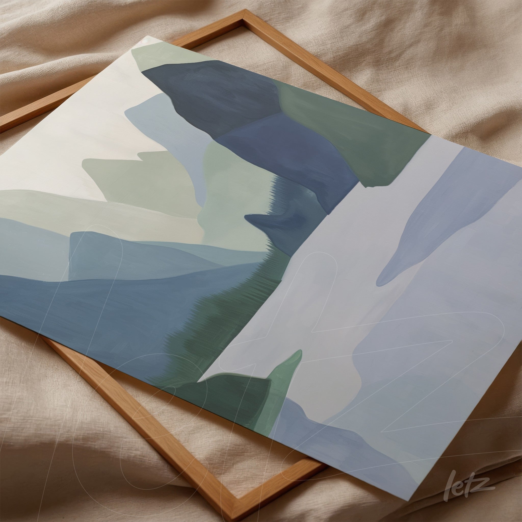 abstract wall art in shades of blue and green displayed in a light wood frame on textured fabric background