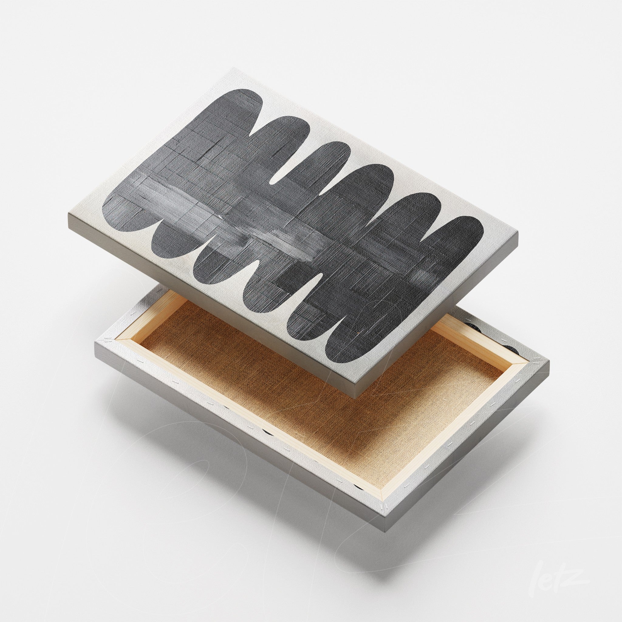 top view of a canvas wall art featuring abstract black and white shapes with a light background