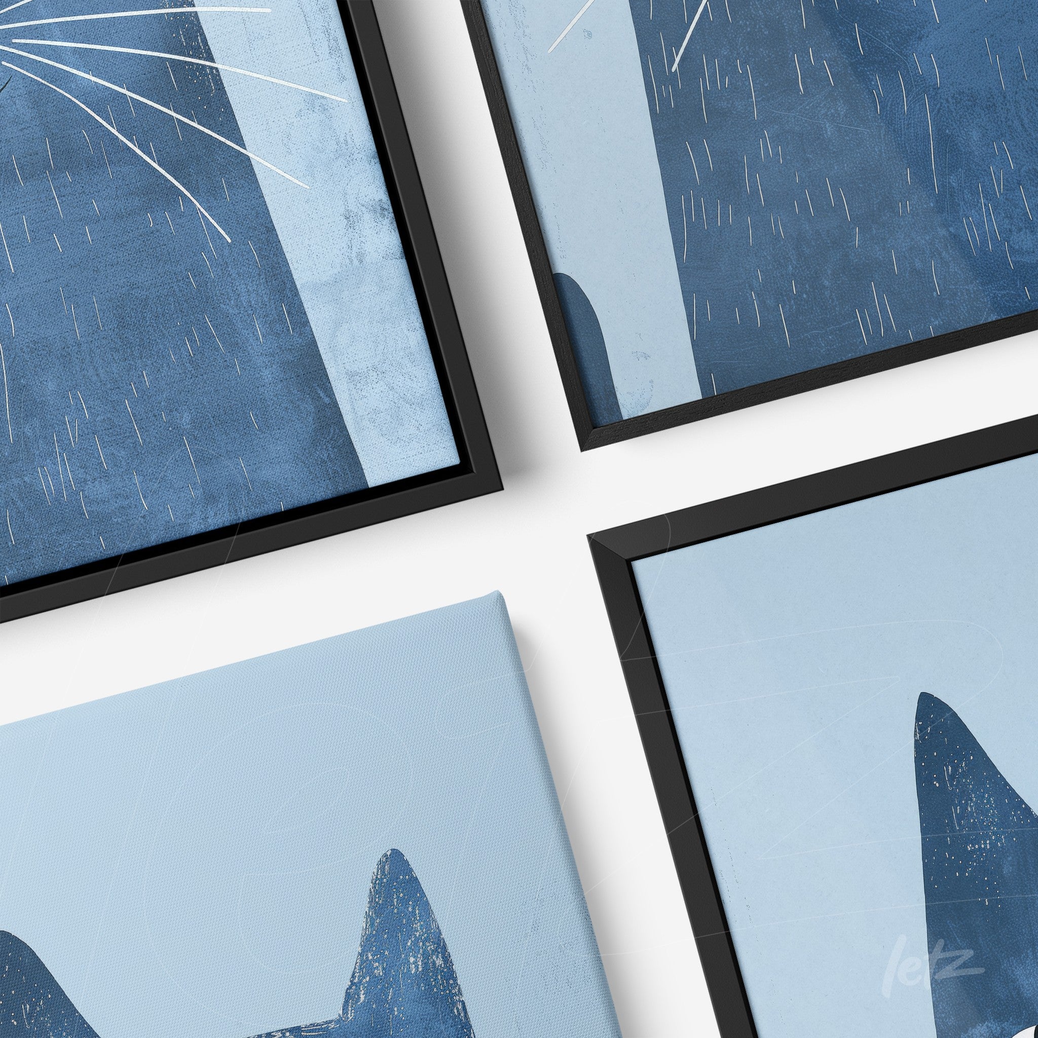 composition of wall art featuring abstract cat illustrations in shades of blue with black frames