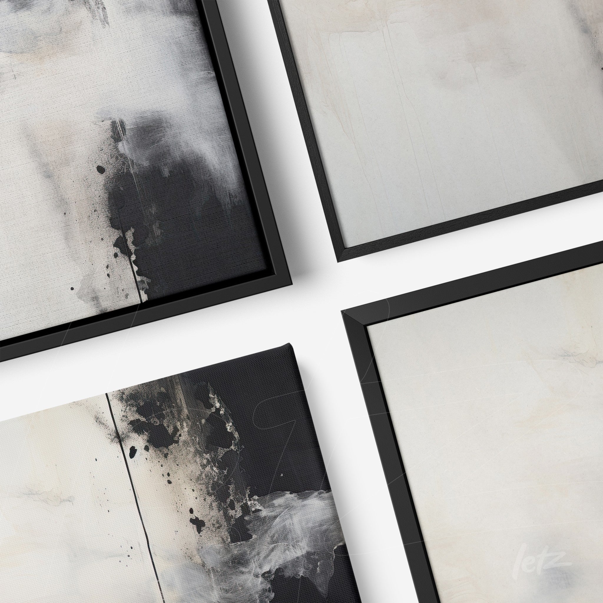 collection of abstract framed wall art in thin black frames featuring soft textures in light and dark tones