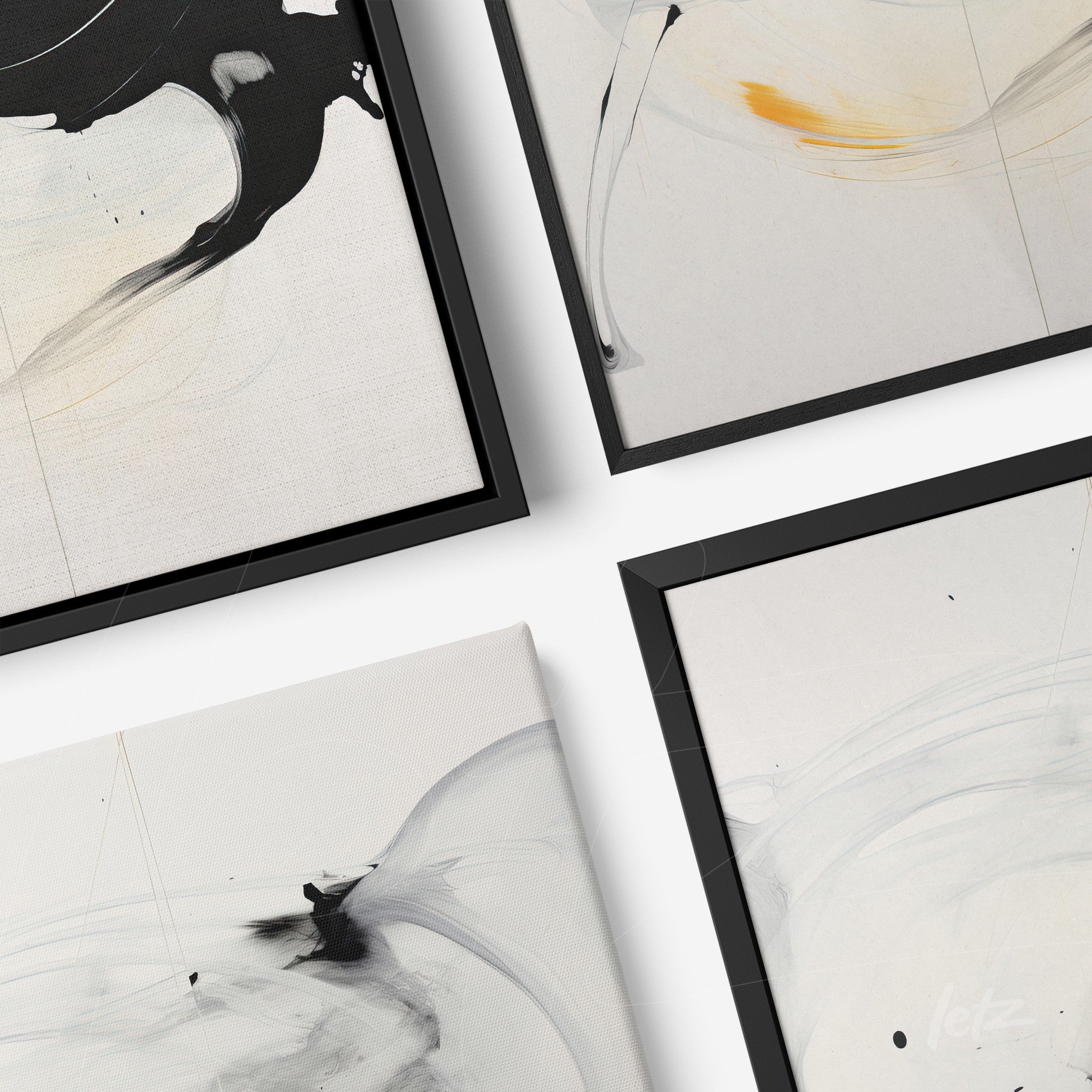 arrangement of black framed artworks featuring abstract designs in black and white