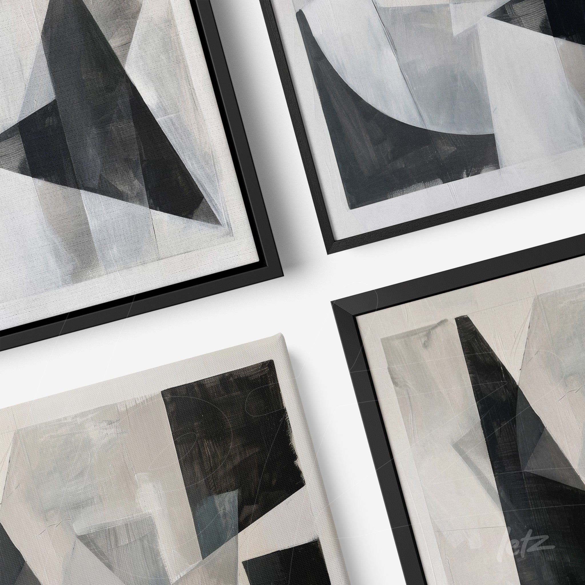 collection of abstract wall art in black, white, and gray with thin black frames