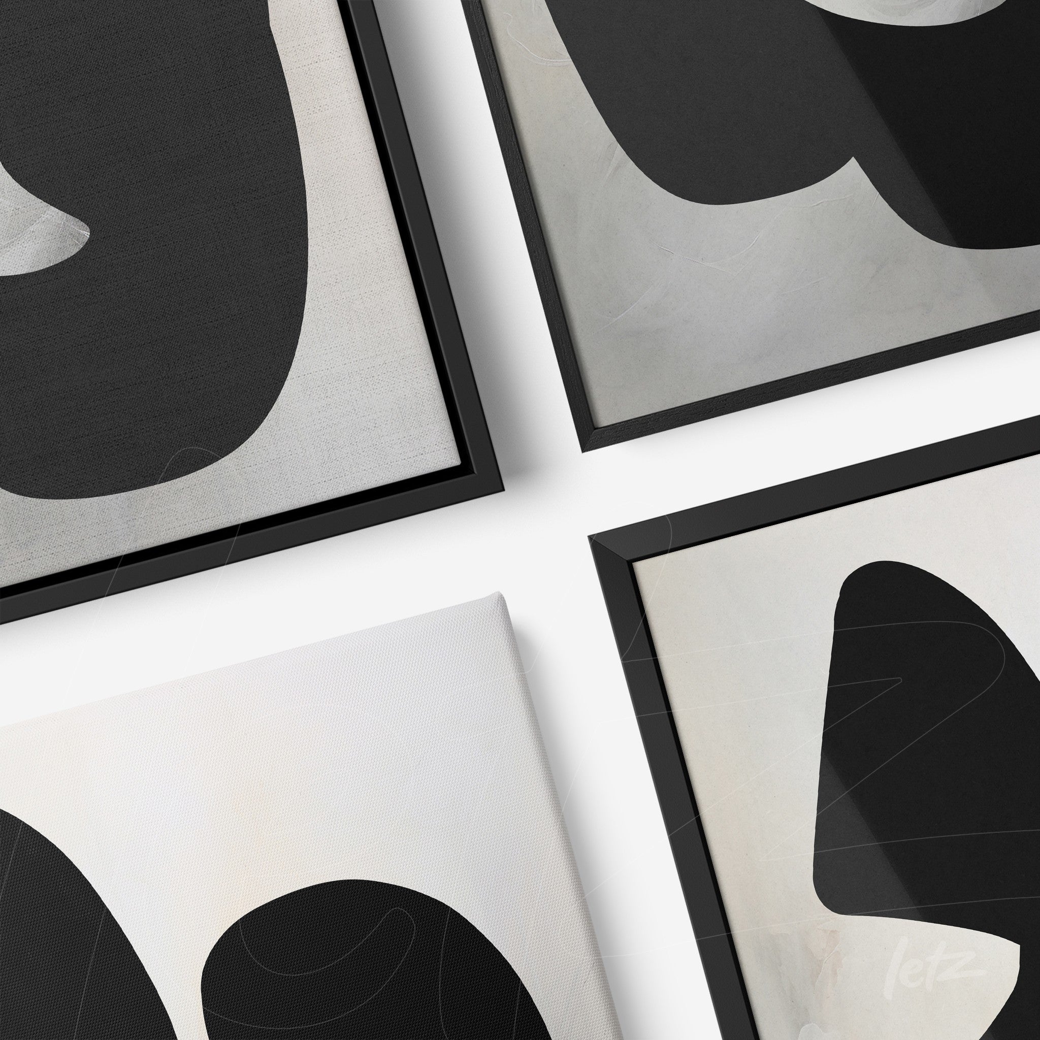 composition of abstract wall art in black and white, featuring thin black frames on a light background