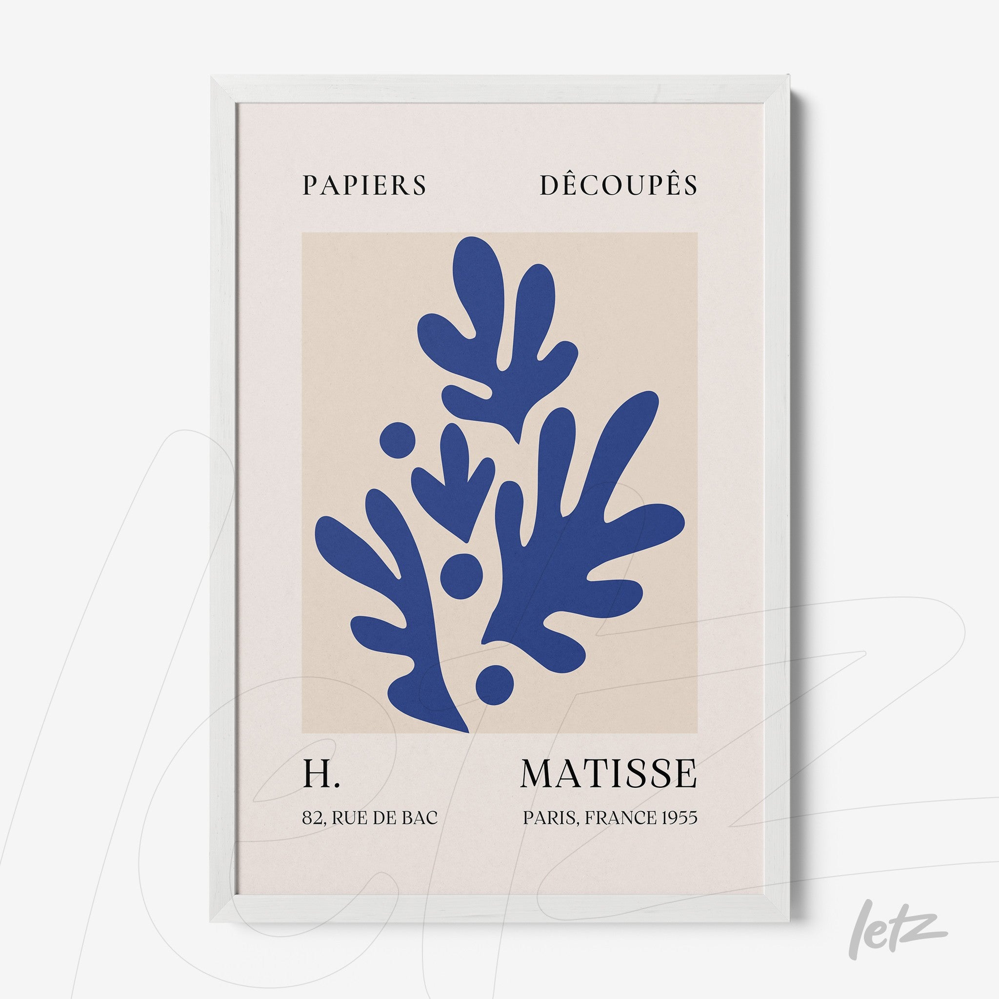 framed artwork featuring cut-out shapes in blue over a neutral background with white frame