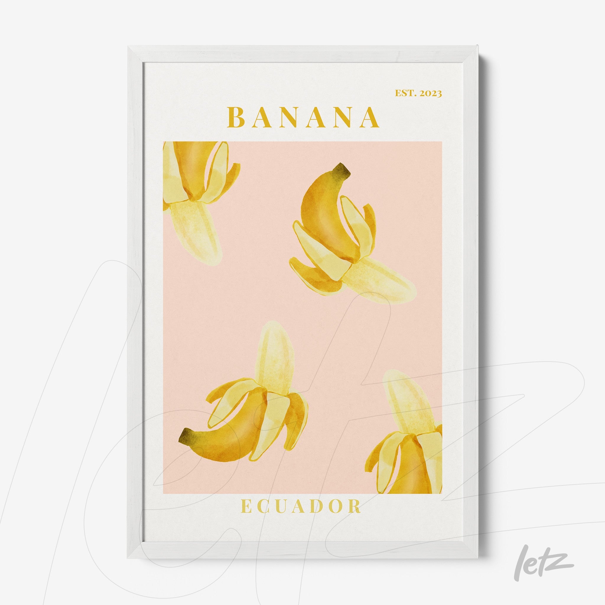 framed wall art featuring yellow bananas on a pink background with white frame