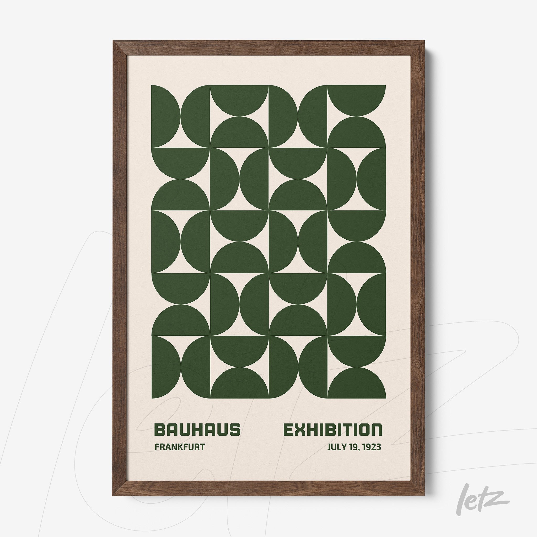 printed poster in bauhaus style with green geometric shapes framed in dark wood