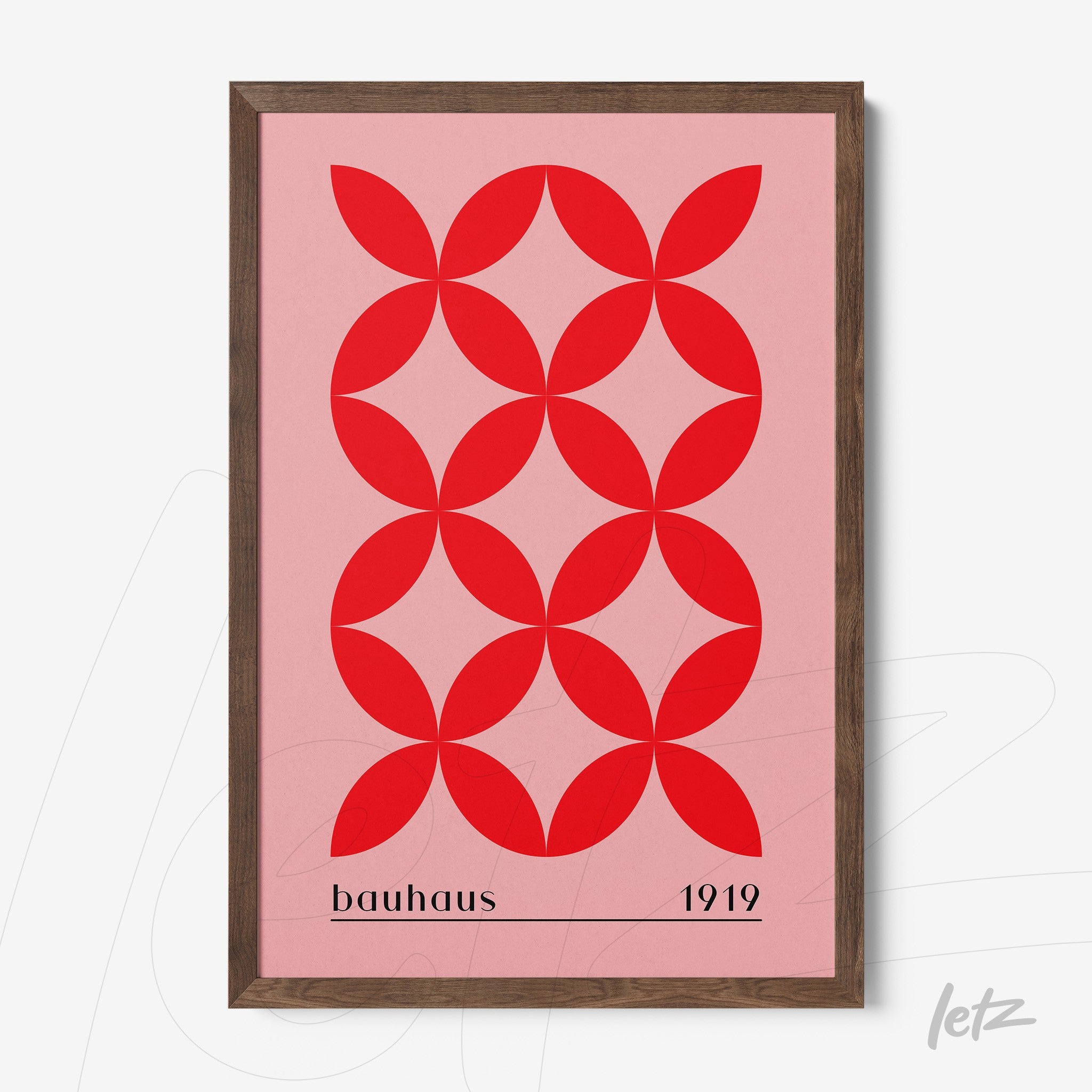 bauhaus style geometric art with interlocking red shapes on pink background in dark wood frame