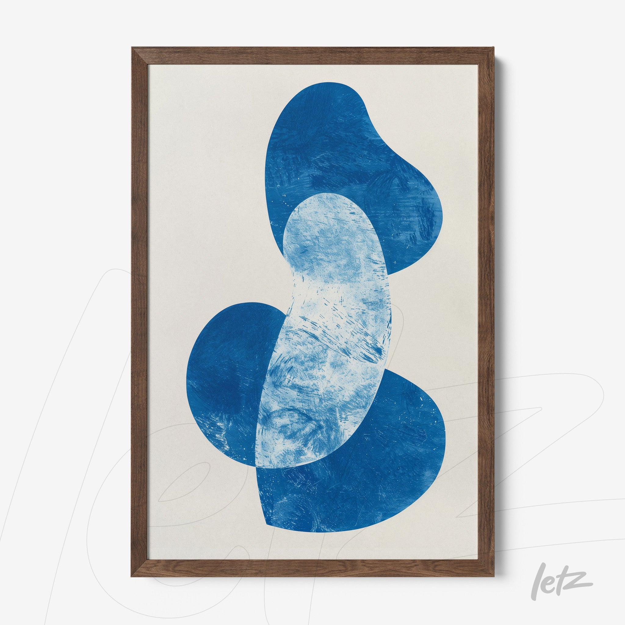 abstract wall art in shades of blue framed in dark wood