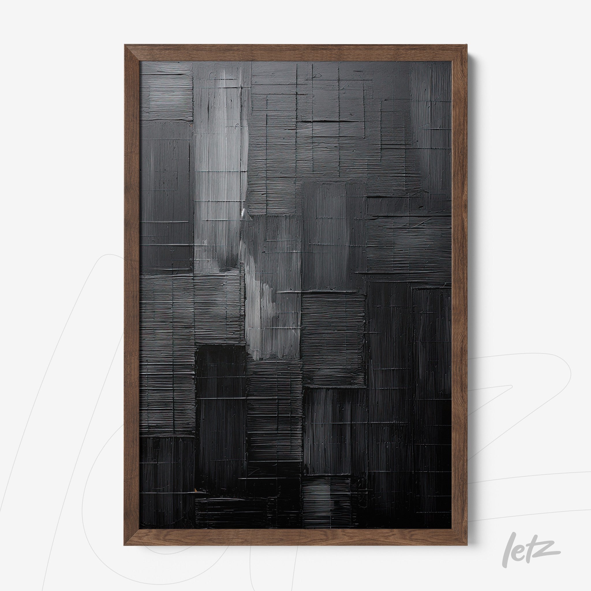 abstract wall art in shades of black and gray framed in dark wood