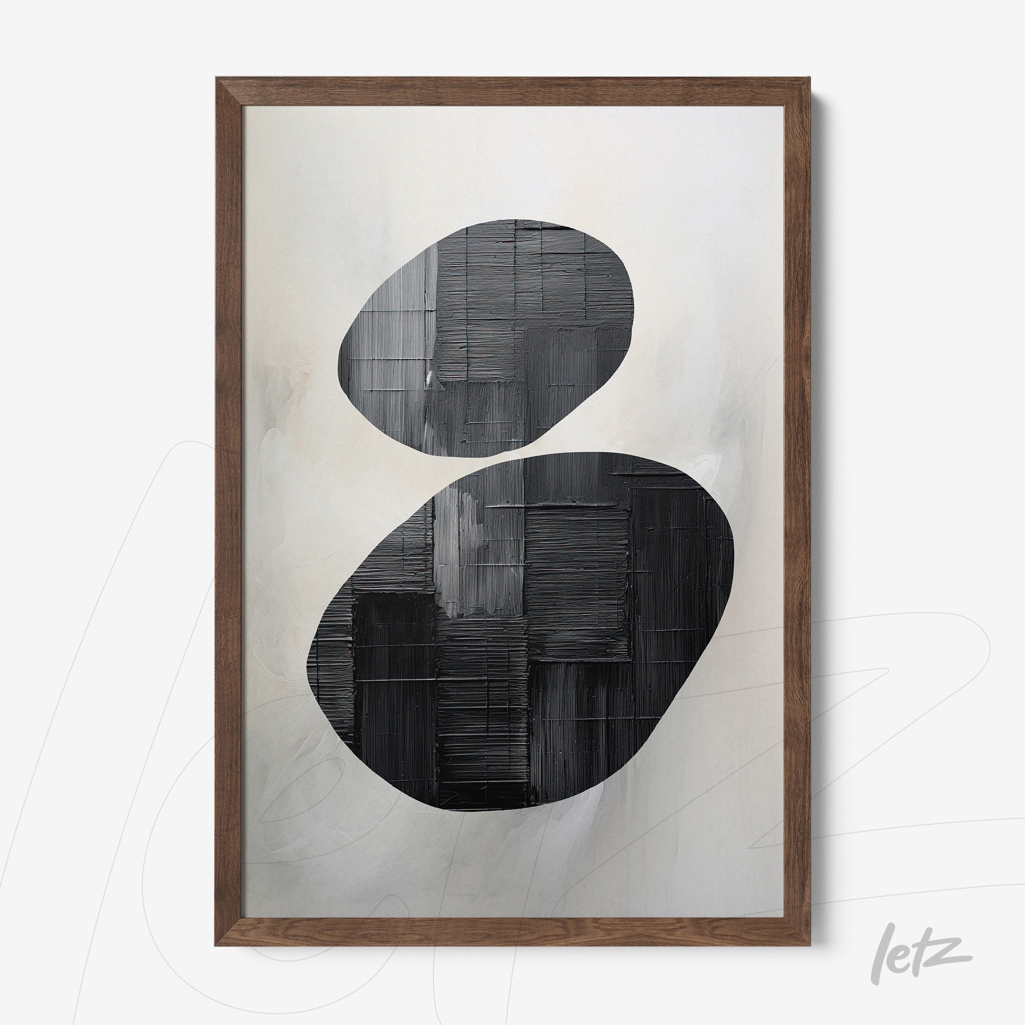 abstract wall art in black and white featuring oval forms in relief on a soft background with dark wooden frame