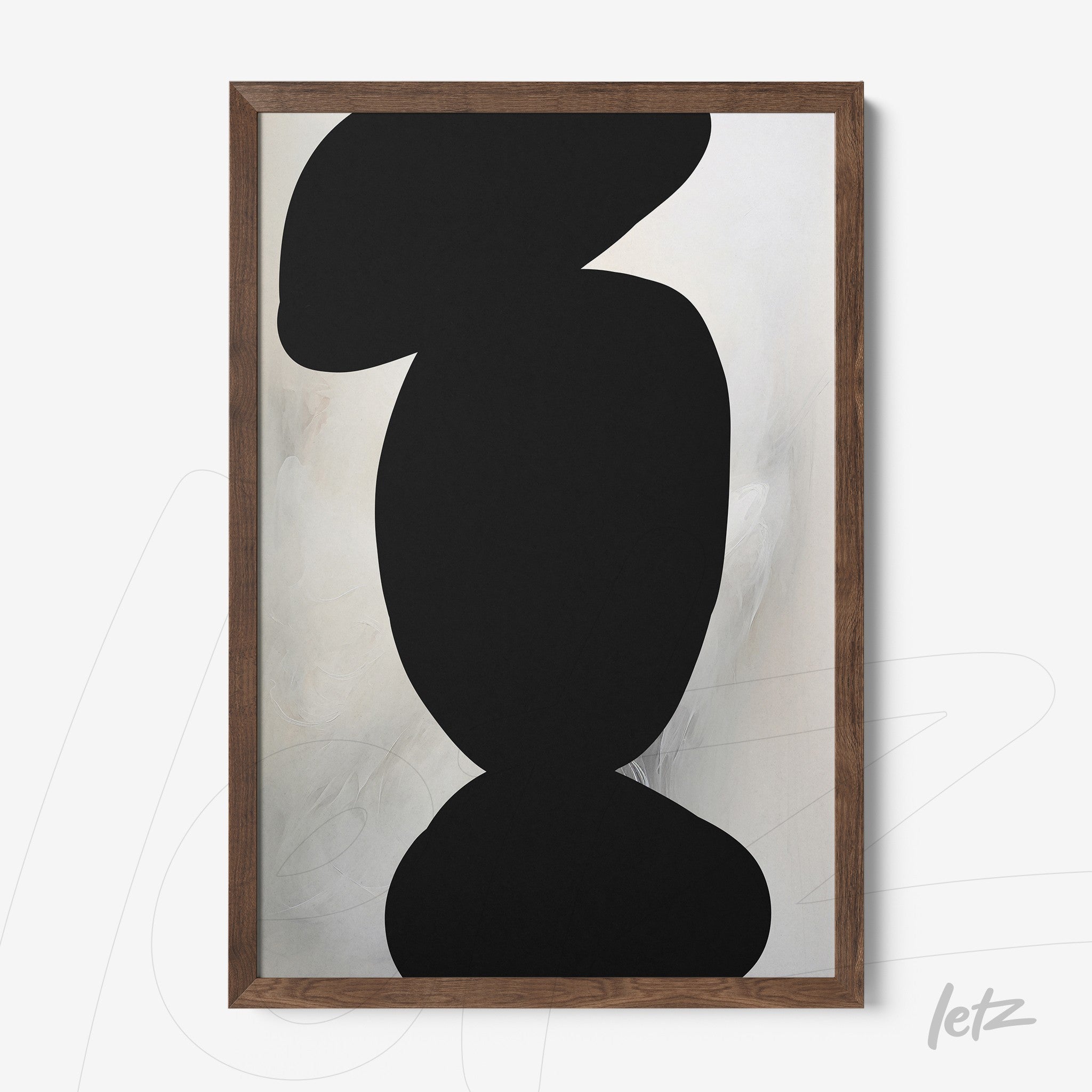 framed abstract art featuring light background and organic black shapes in dark wood frame