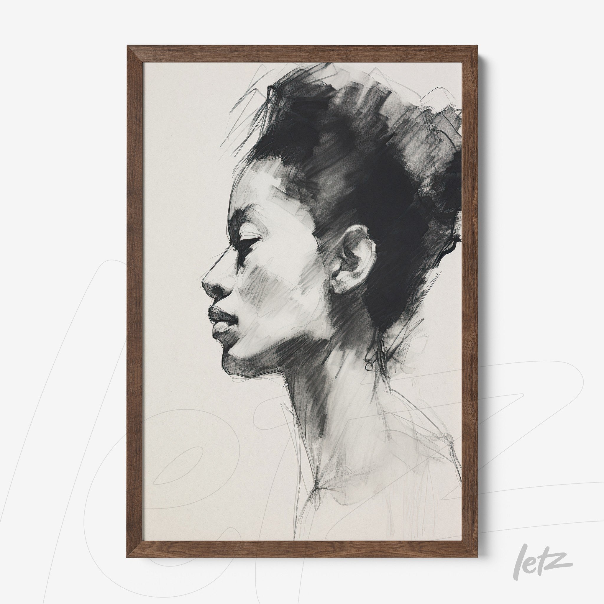 framed black and white artwork of a female profile with dark wooden frame