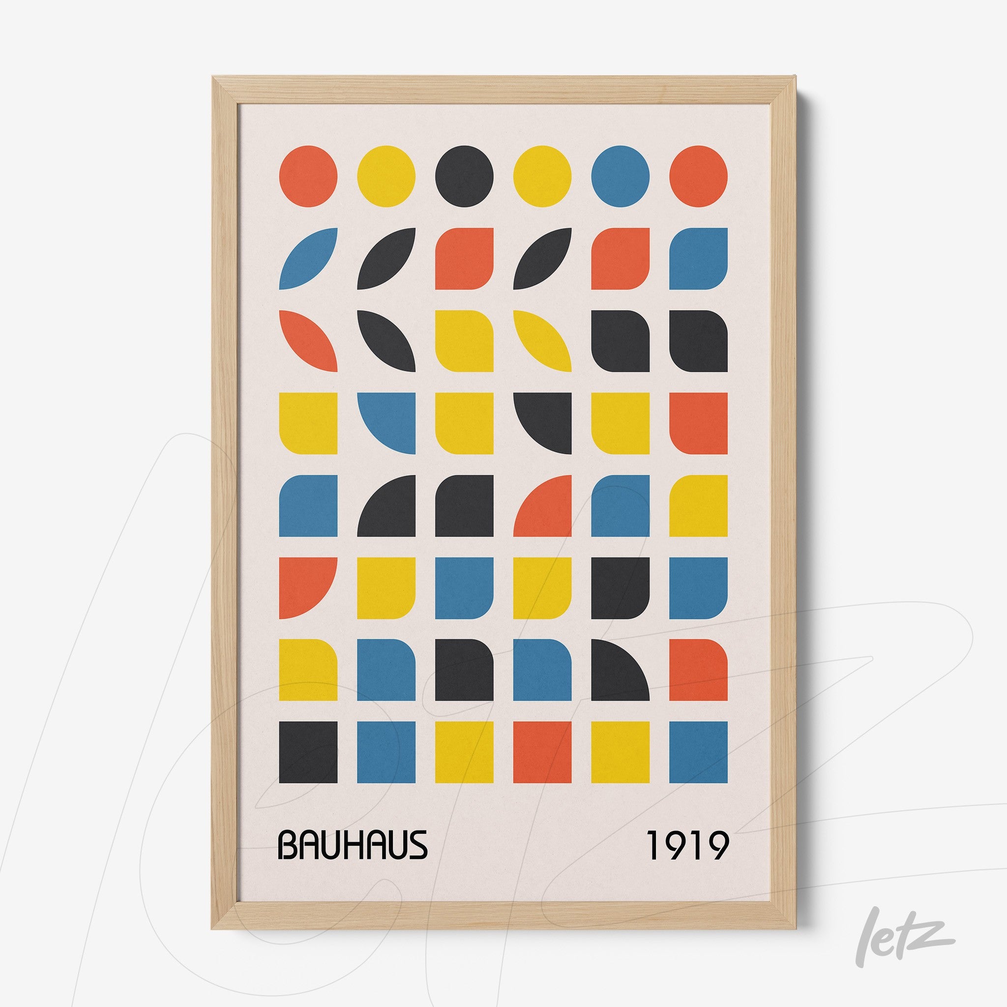 poster with colorful geometric Bauhaus style design from 1919 in light wood frame