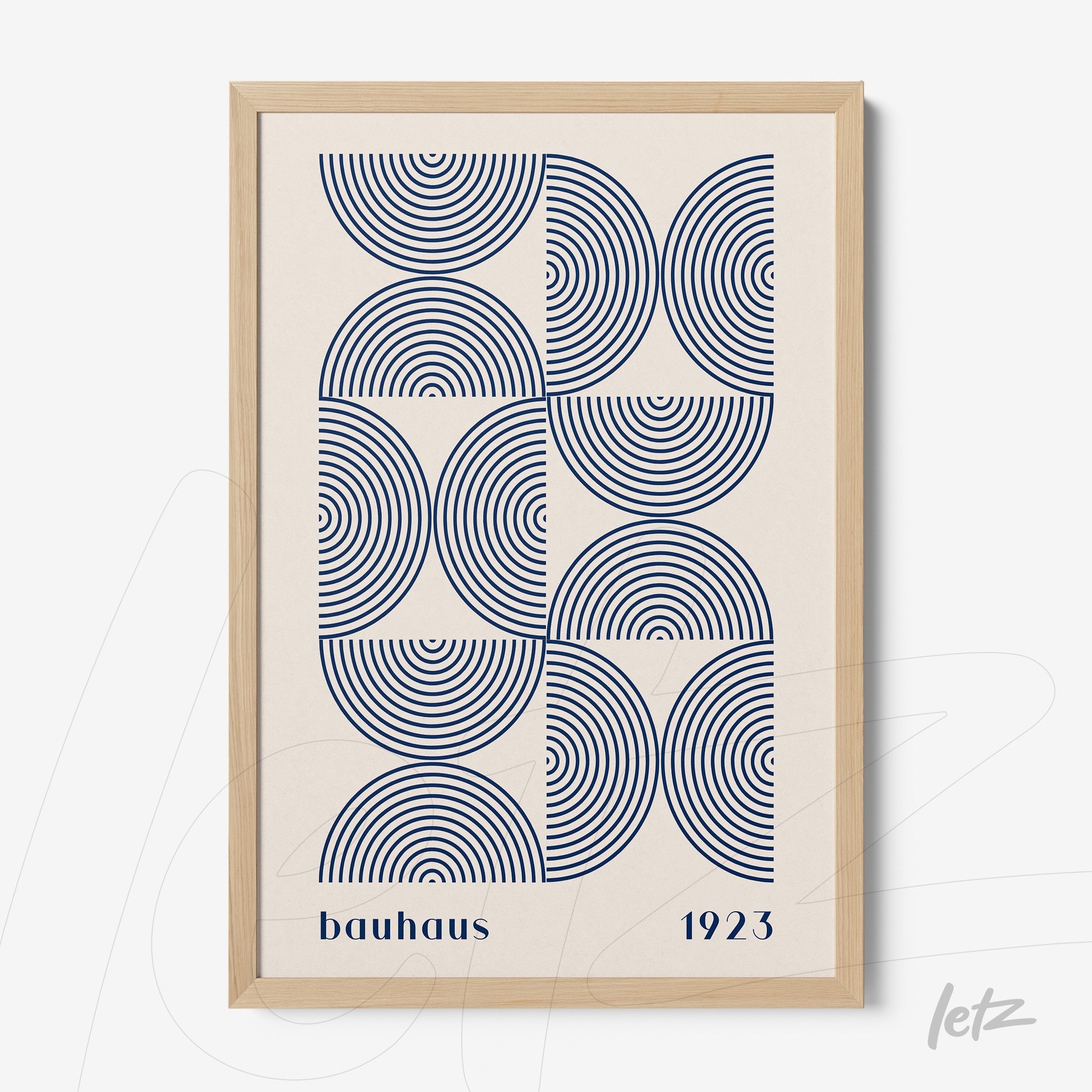 poster with geometric art in blue featuring concentric circles in a light wood frame