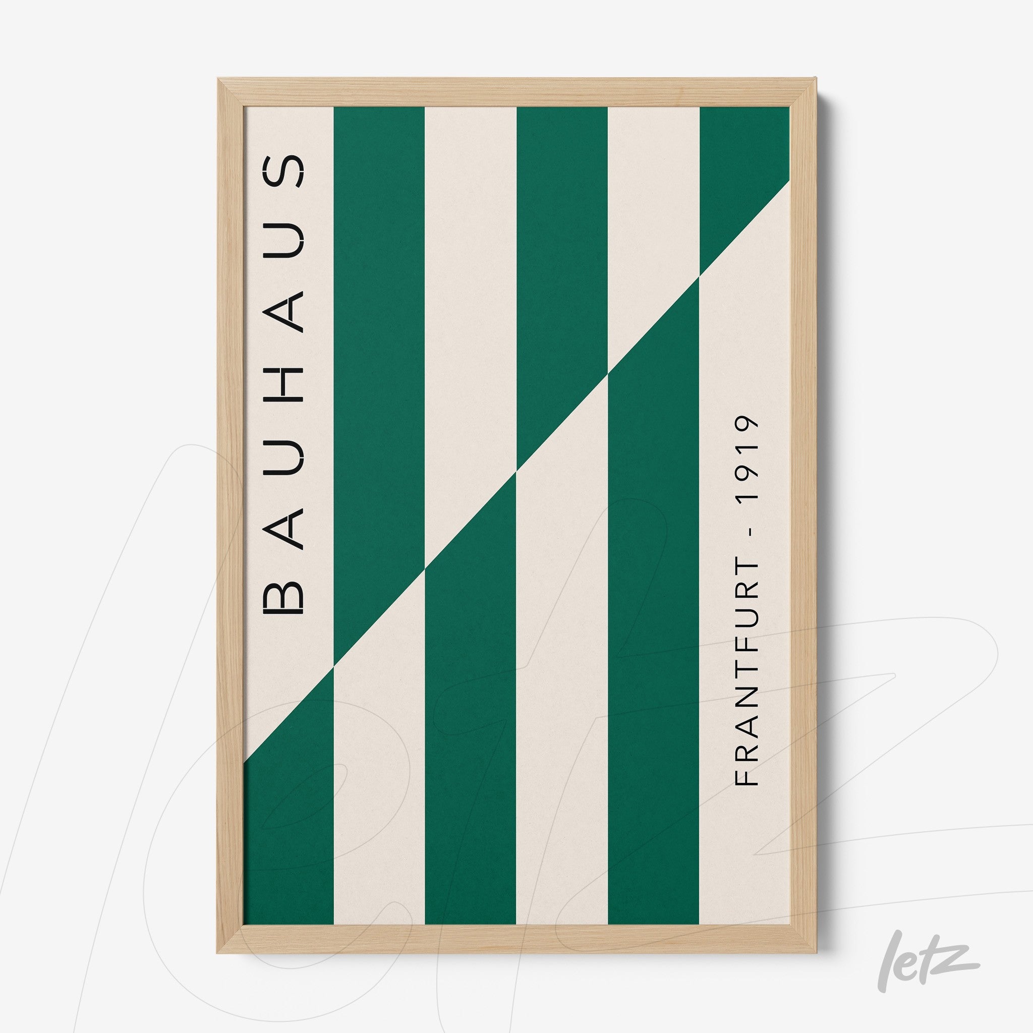 geometric art with vertical green and white stripes in light wood frame featuring text 'bauhaus' and 'frankfurt - 1919'