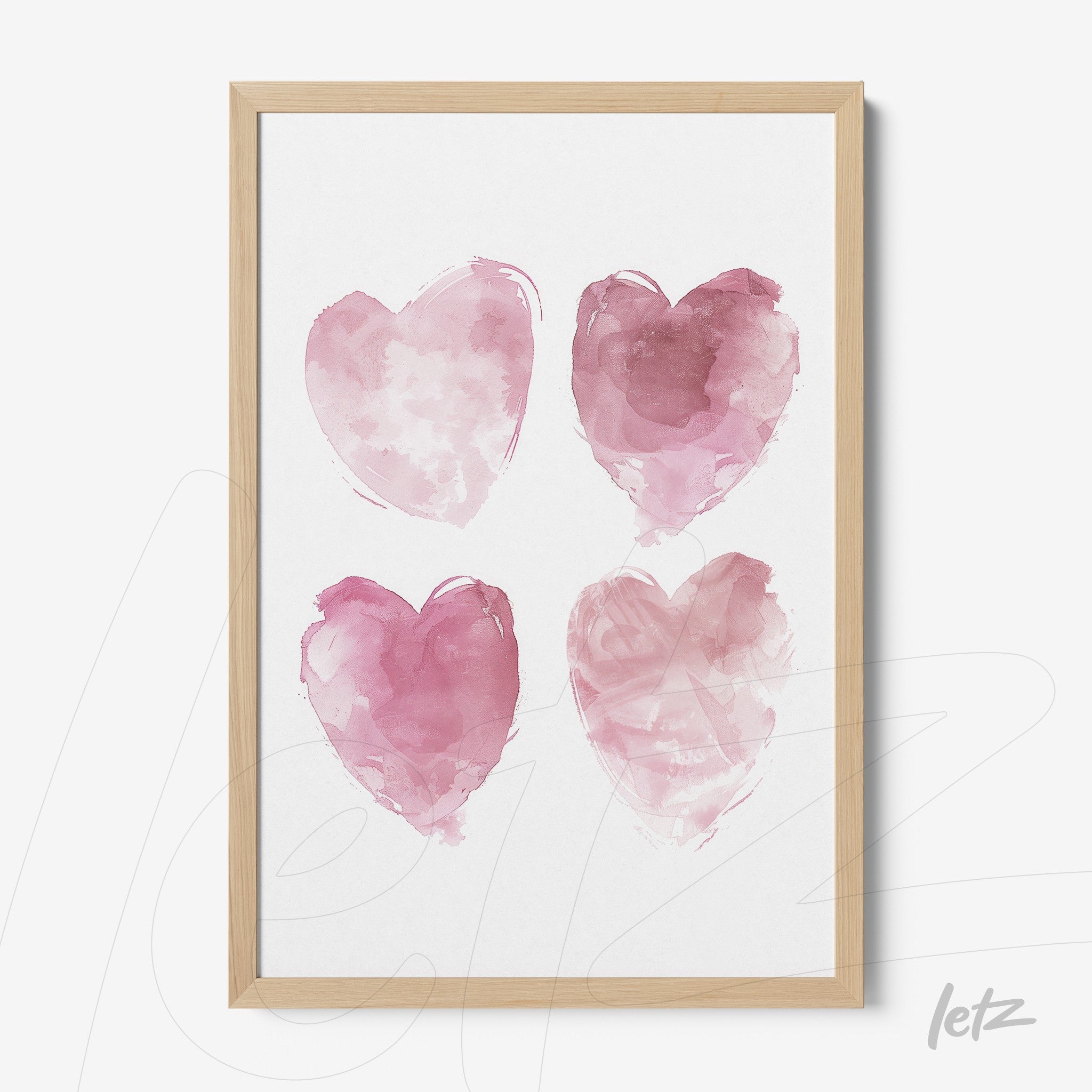 framed wall art featuring four pink watercolor hearts in light wood frame