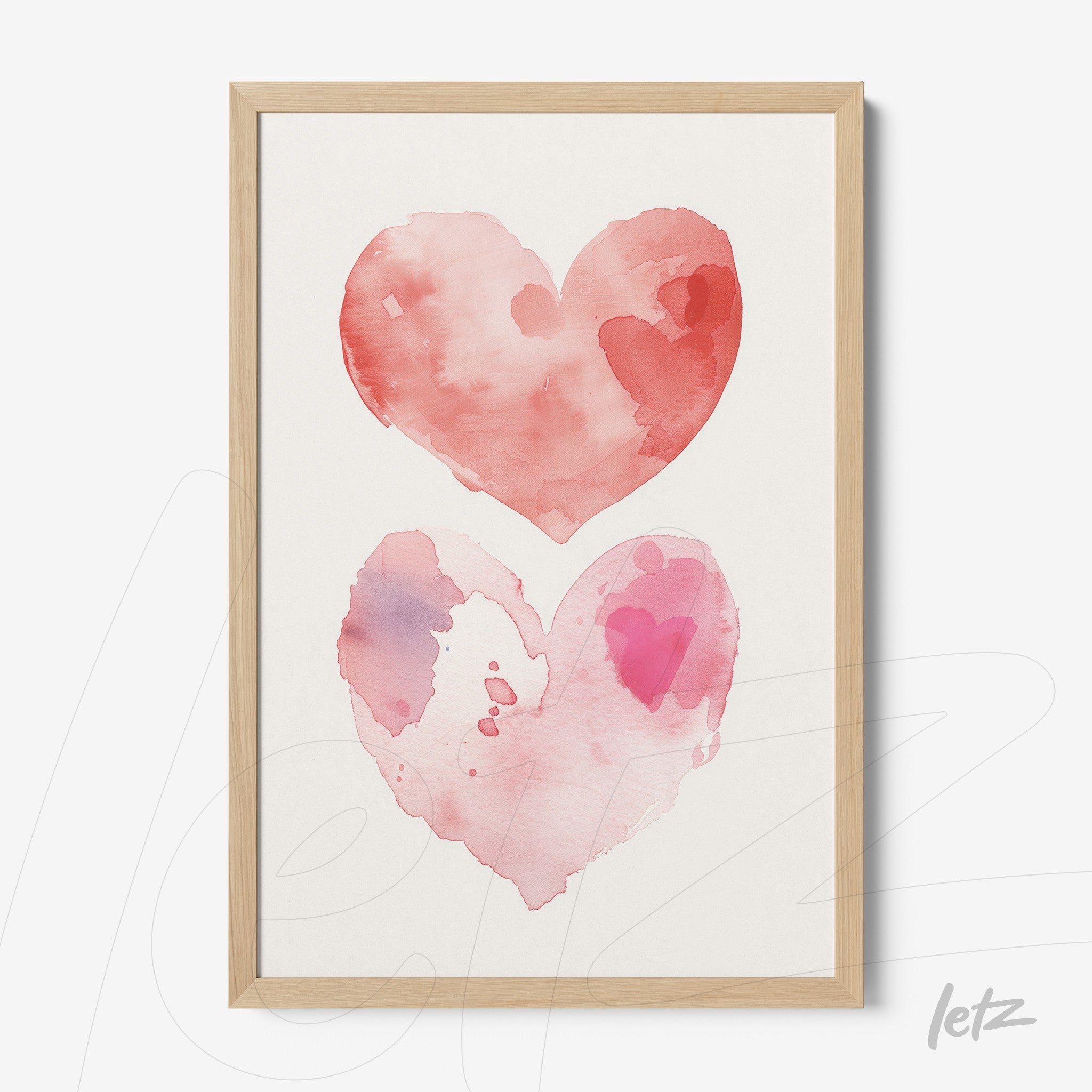 framed wall art featuring watercolor illustration of two hearts in shades of pink and red with light wood frame
