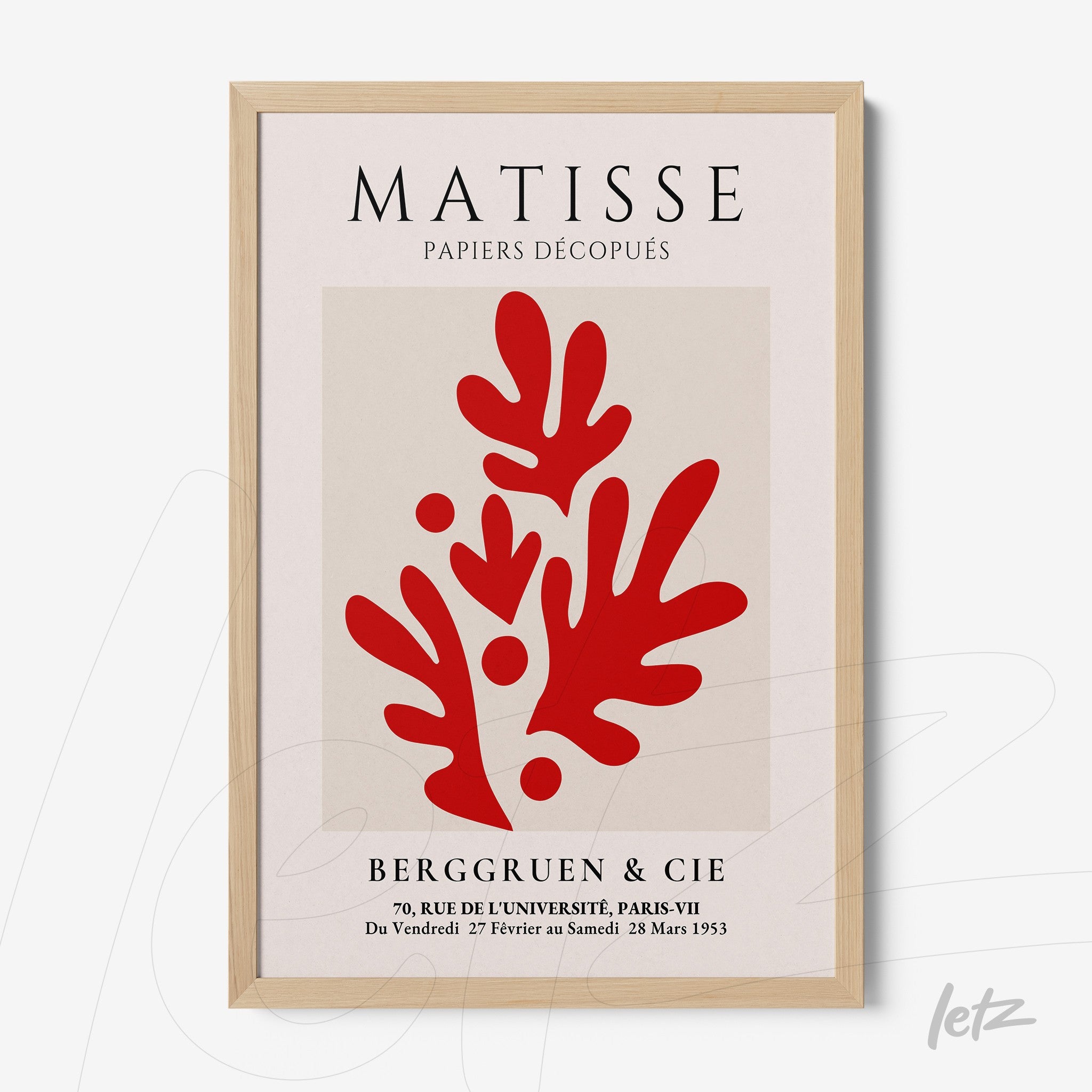 framed wall art featuring red paper cutout design with light wooden frame and neutral background