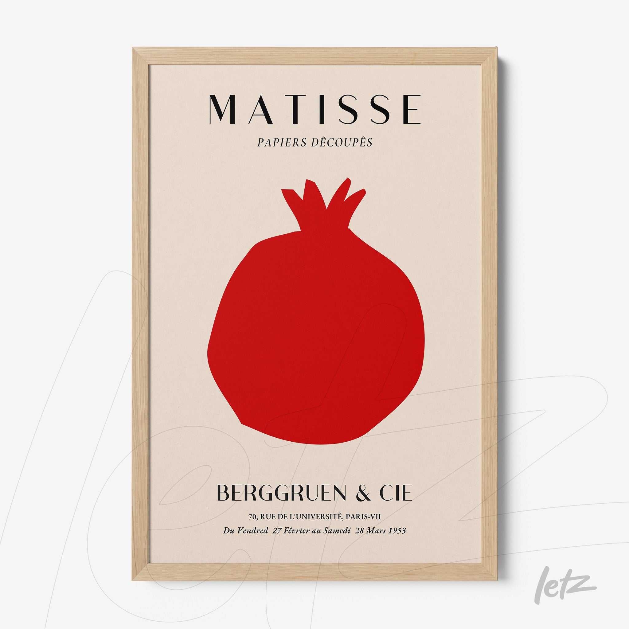 framed modern art featuring a red pomegranate on a light background with a light wood frame