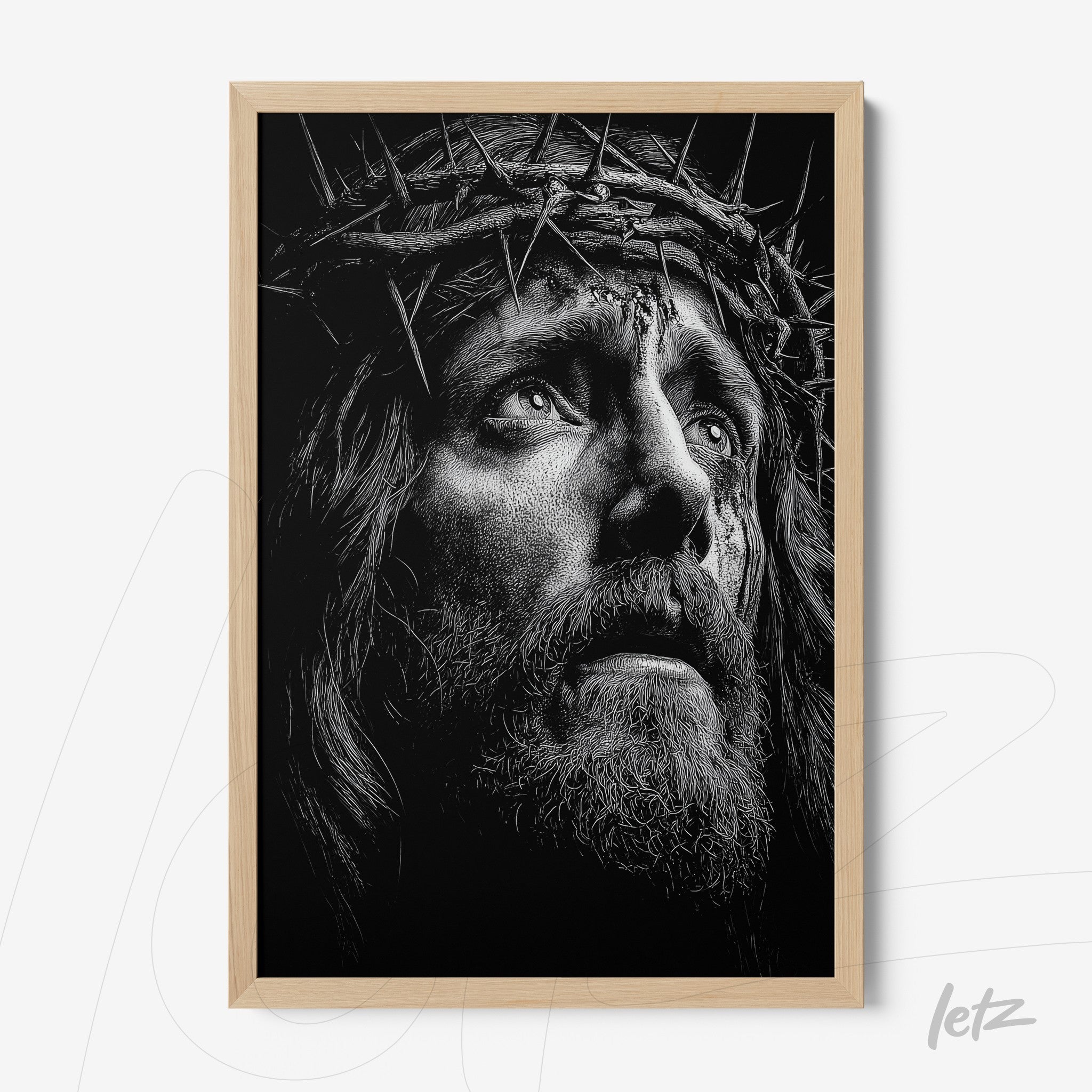framed black and white portrait of a religious figure wearing a crown of thorns with light wood frame