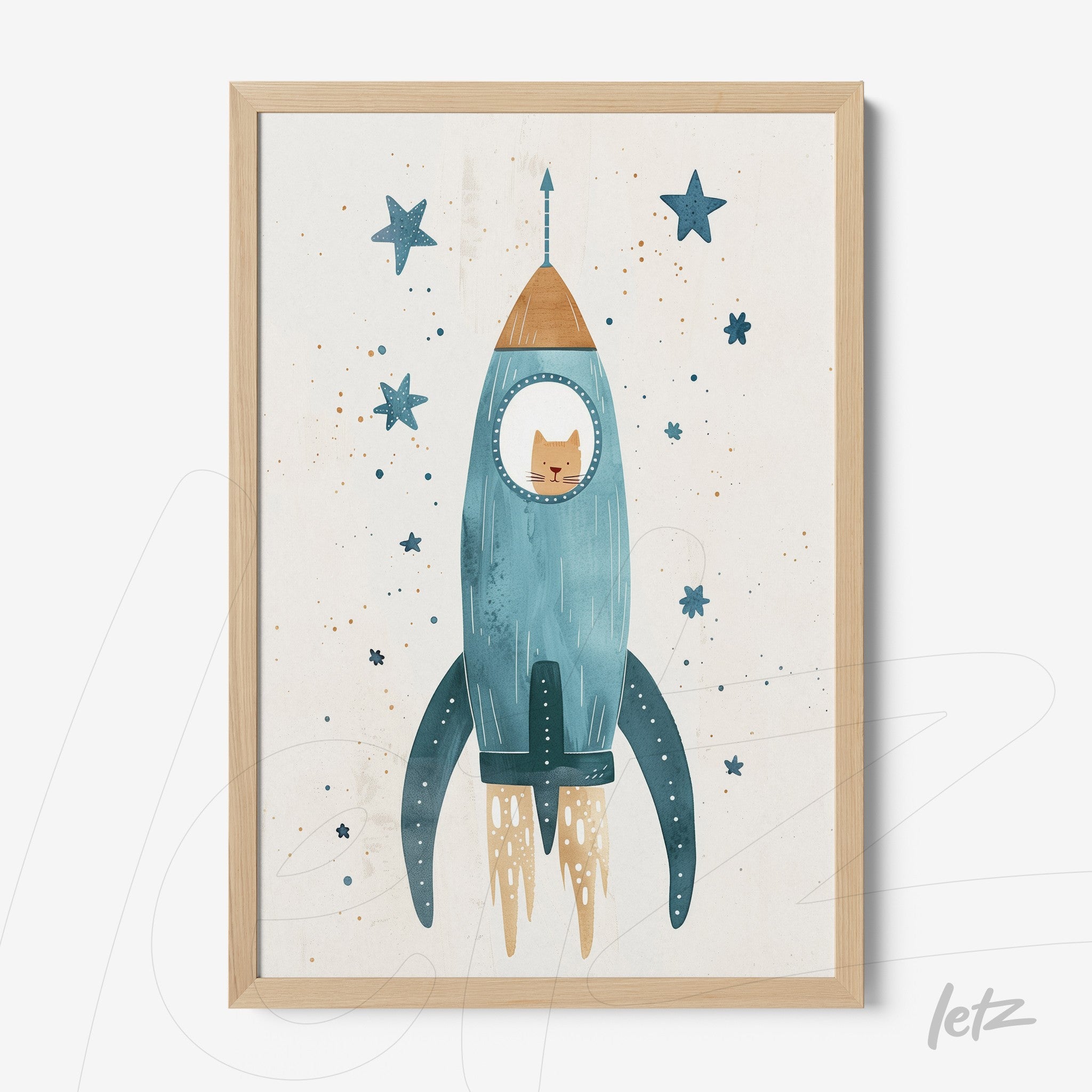 framed artwork featuring a blue rocket with a cat inside and stars surrounding, in a light wooden frame