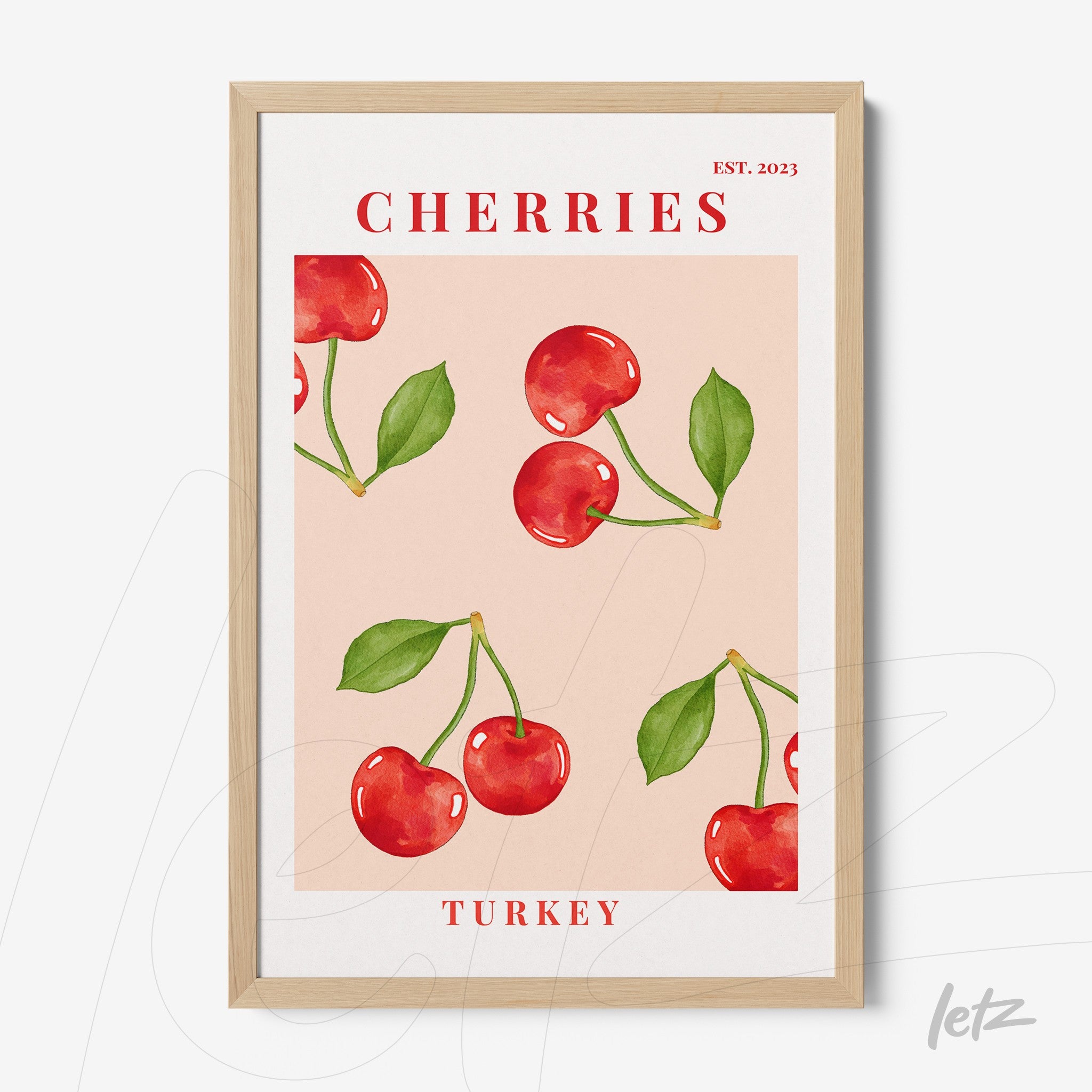 framed artwork featuring cherries on a light pink background with a light wood frame