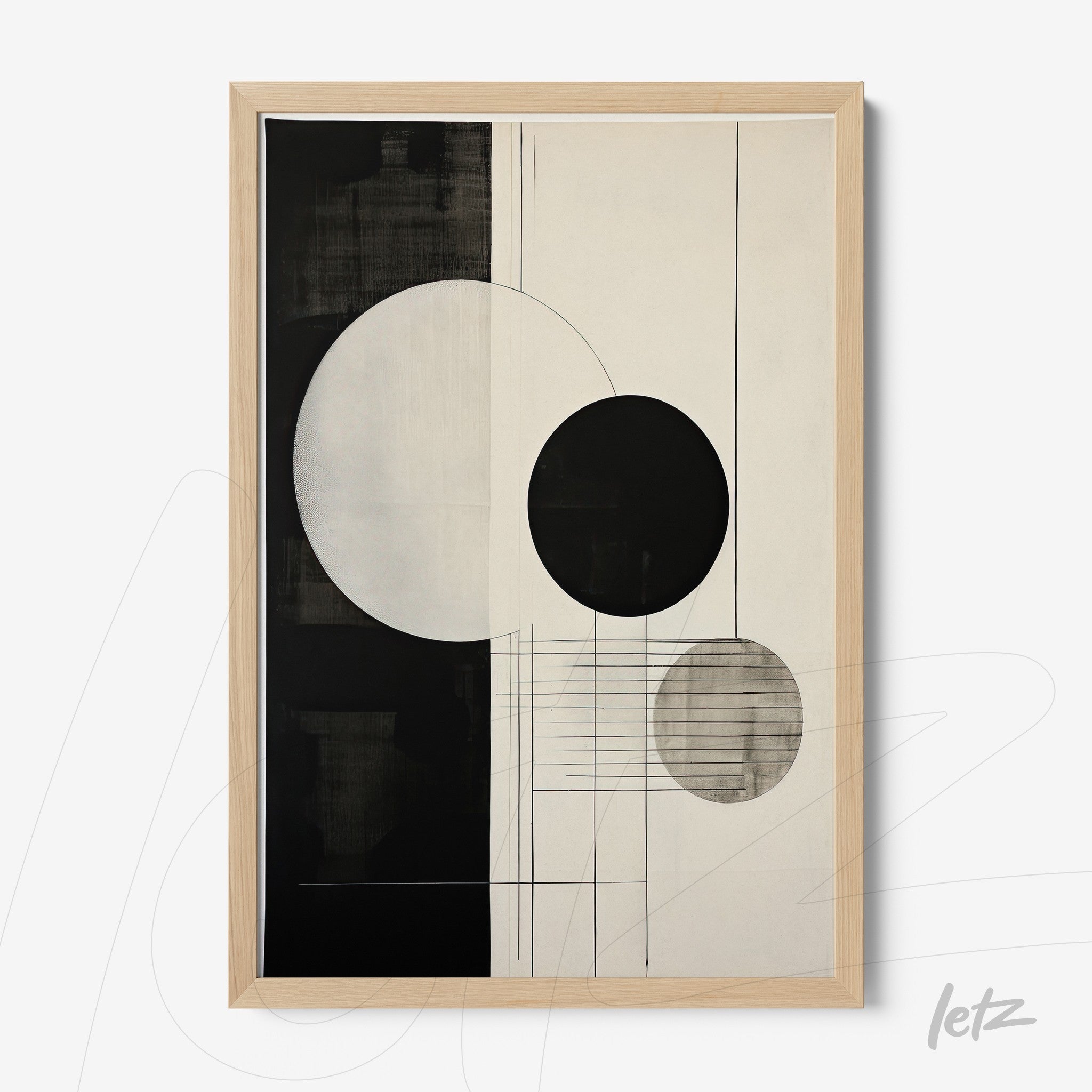 abstract wall art in black and white featuring circles and lines, framed with light wood