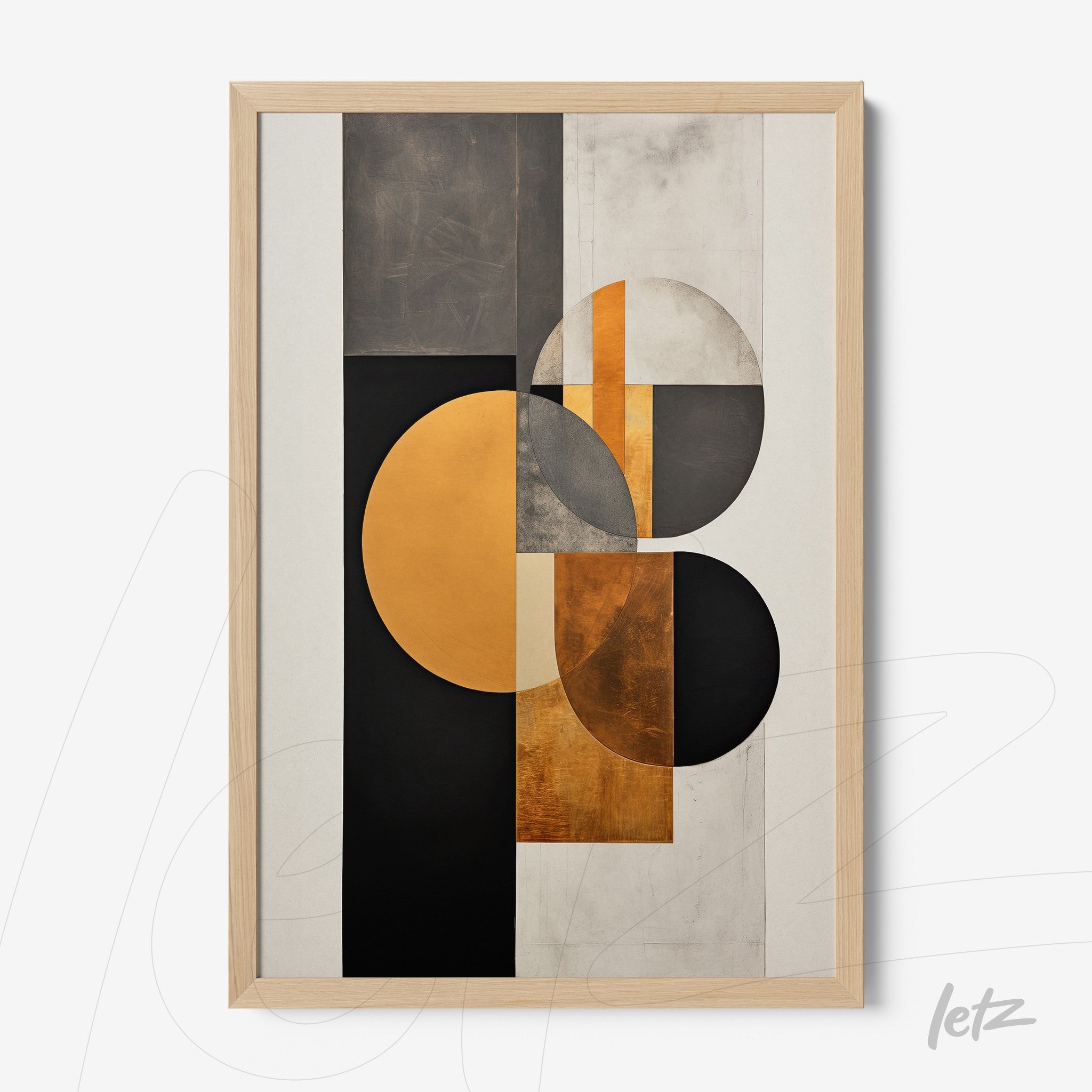 framed geometric wall art in black, white, and gold tones with light wood frame
