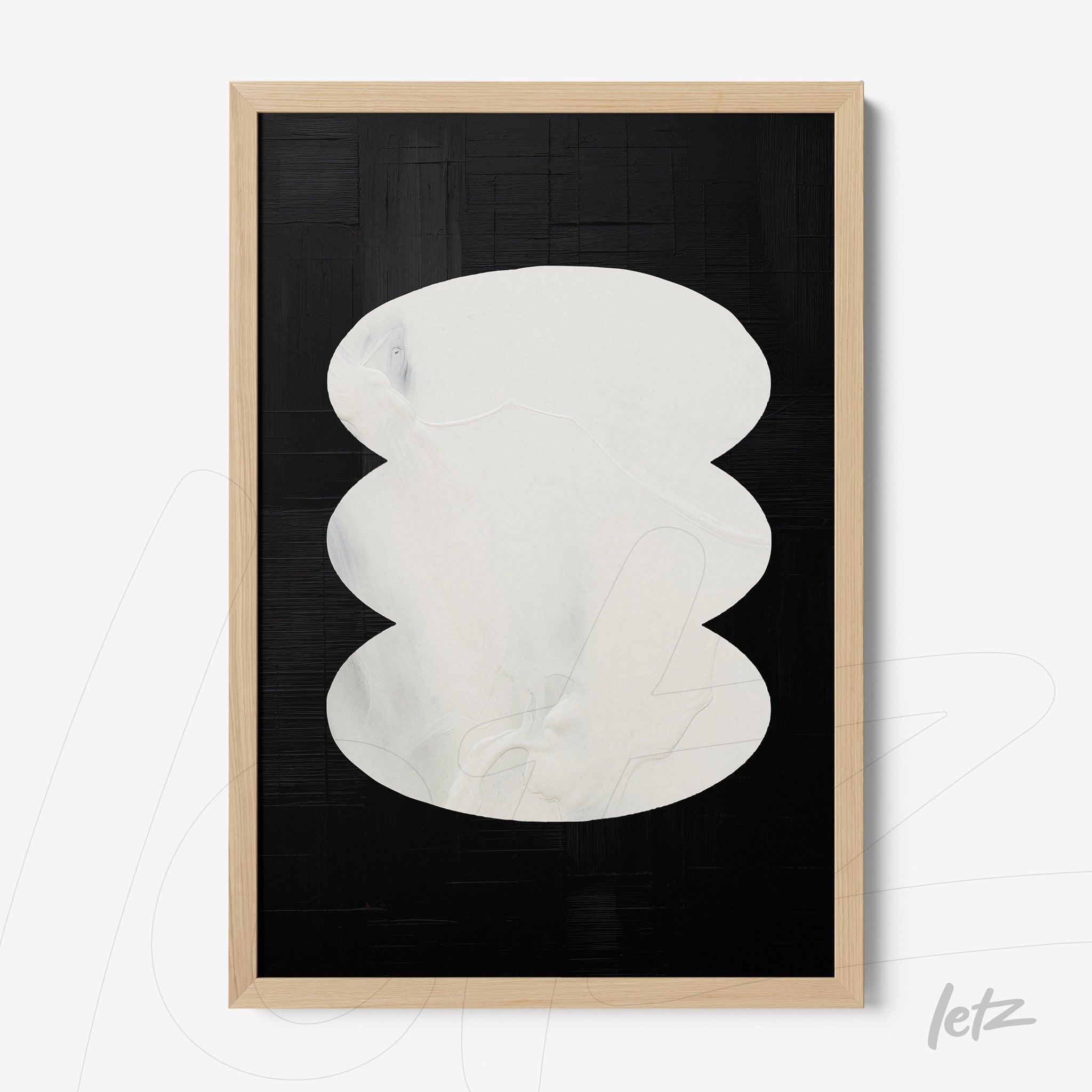 abstract wall art with dark tones and prominent white shapes, light wood frame