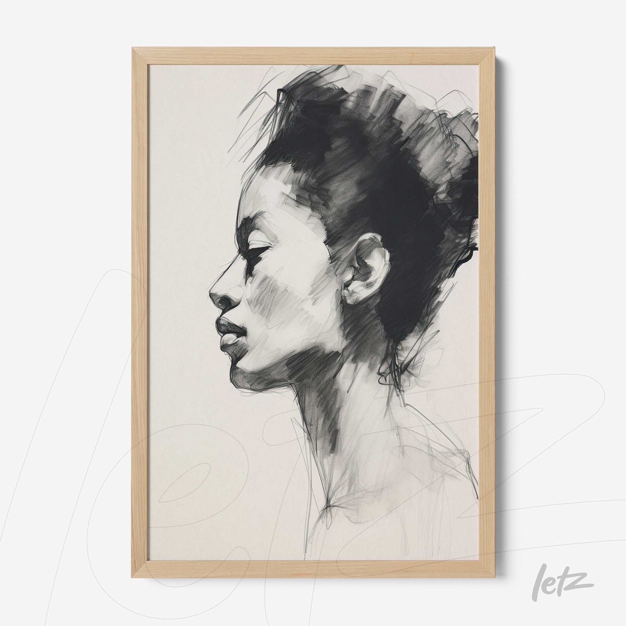 framed artwork featuring a black and white illustration of a young woman's profile with a light wood frame