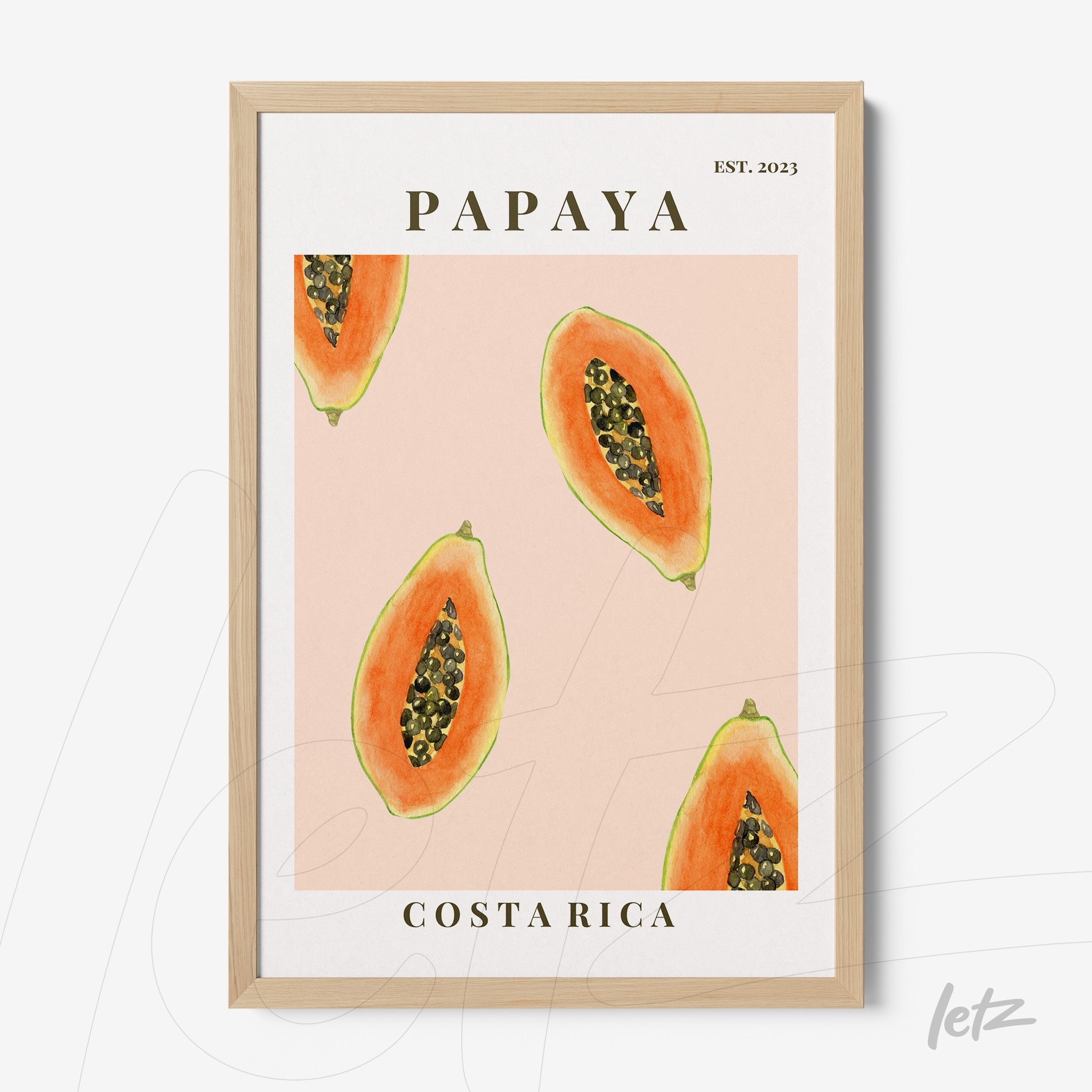 framed wall art featuring illustrations of papaya slices on a pink background with light wooden frame