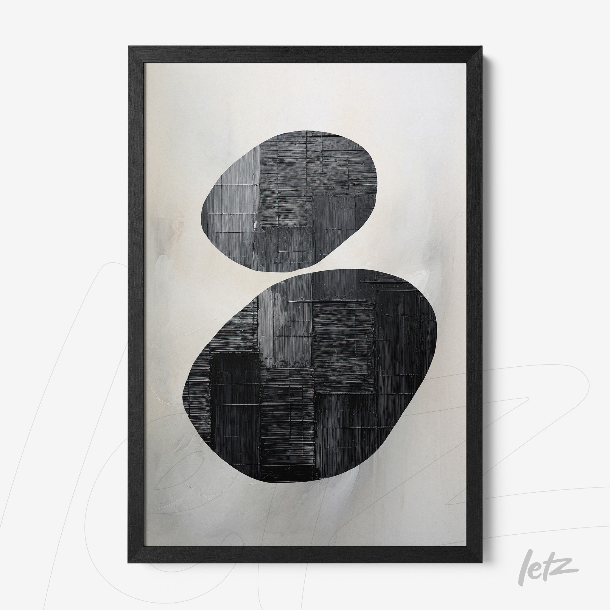 abstract wall art featuring black and gray oval shapes on a soft background