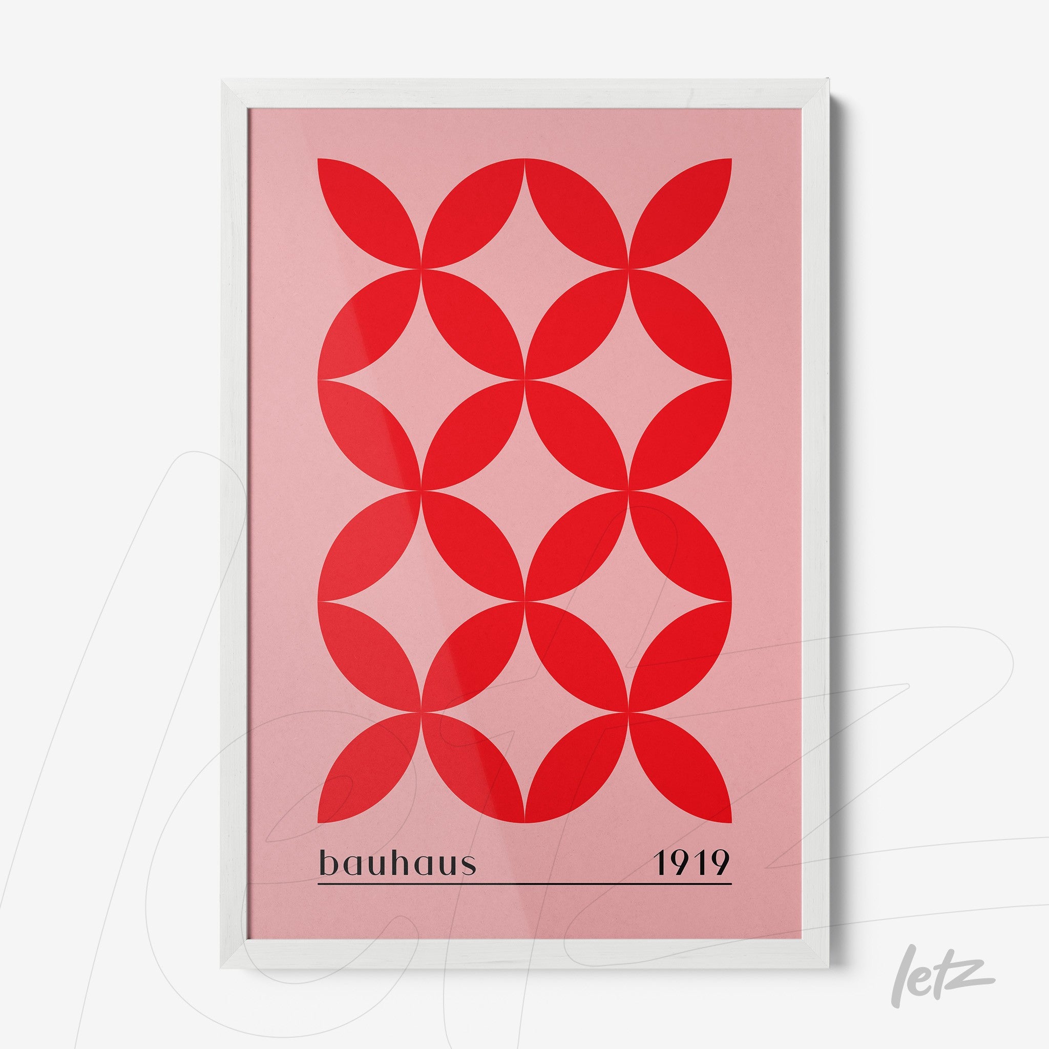 framed wall art of red geometric pattern on pink background in Bauhaus style with white frame