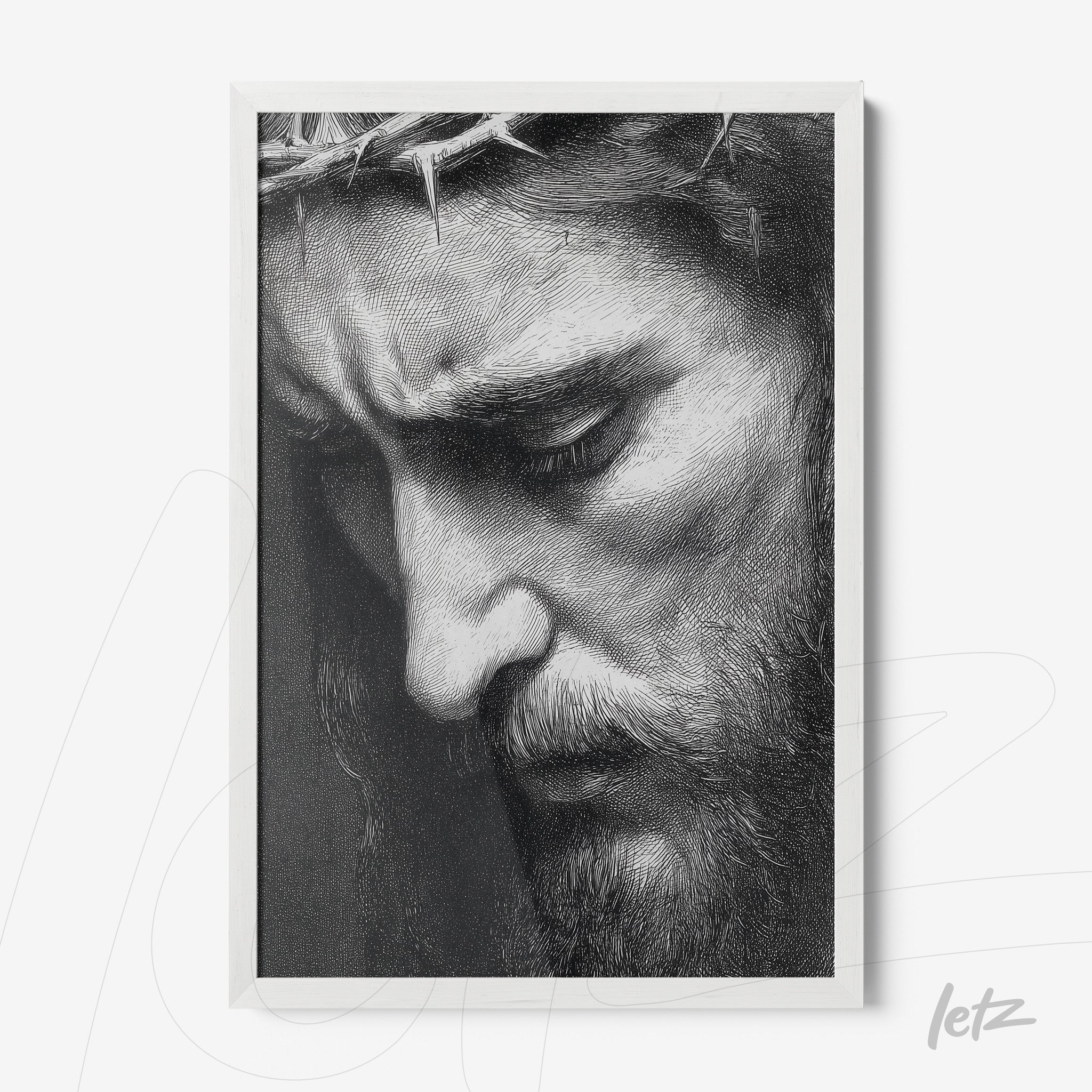 framed black and white portrait of a bearded male figure showing sorrow with a white frame