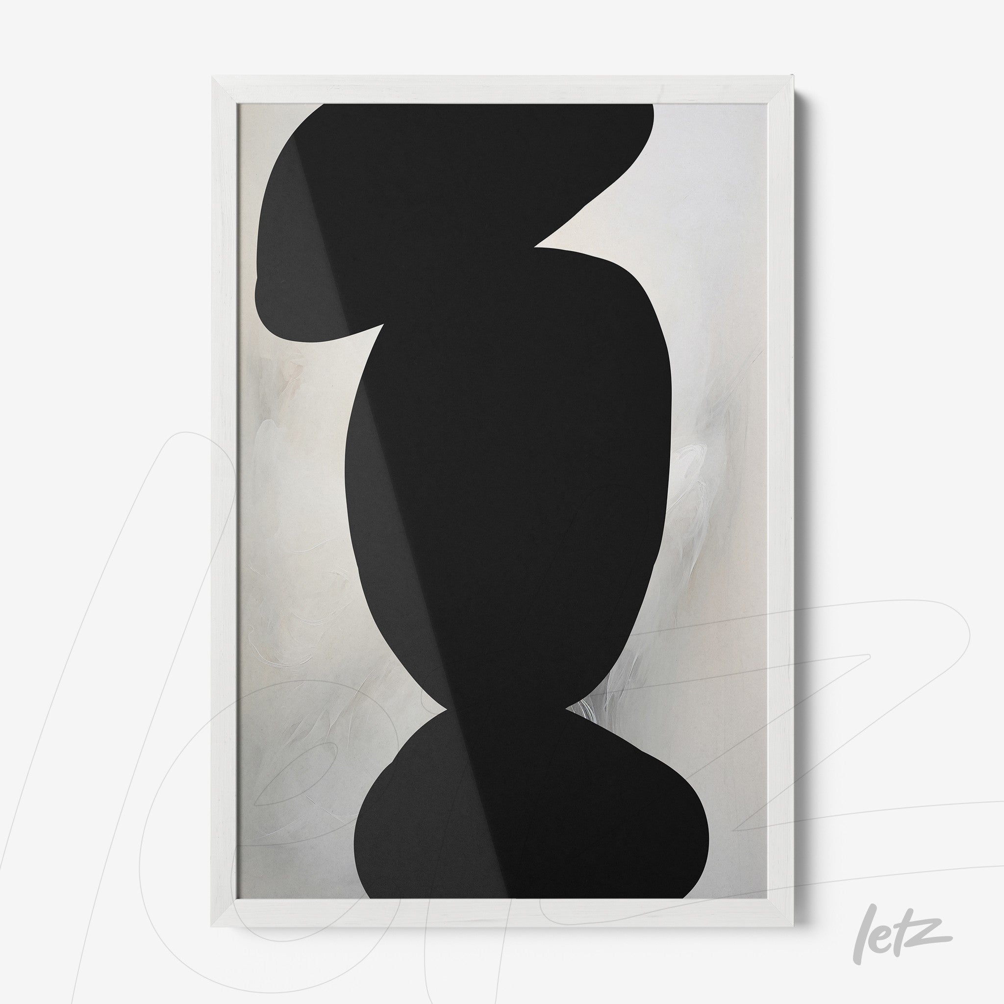 abstract wall art featuring black shapes on a light background with a white frame
