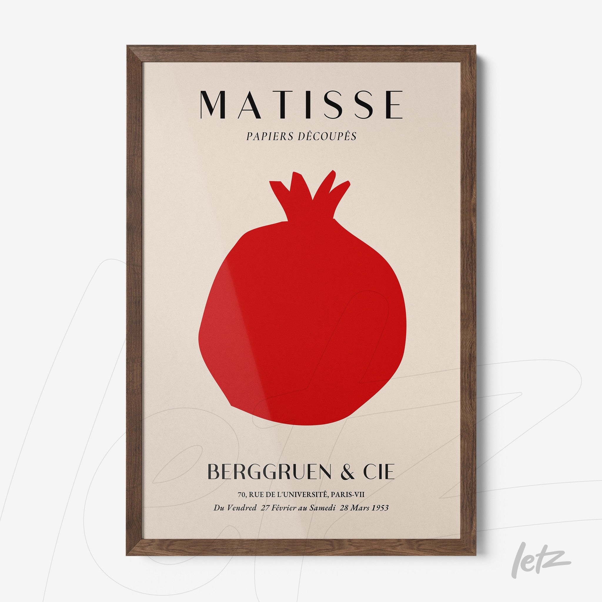 framed art print featuring a stylized cut-out of a pomegranate in a light background with dark wood frame