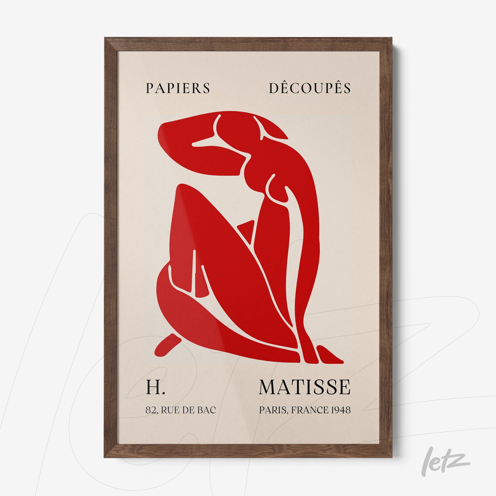 framed modern art featuring a red stylized female figure with a dark wood frame and light background